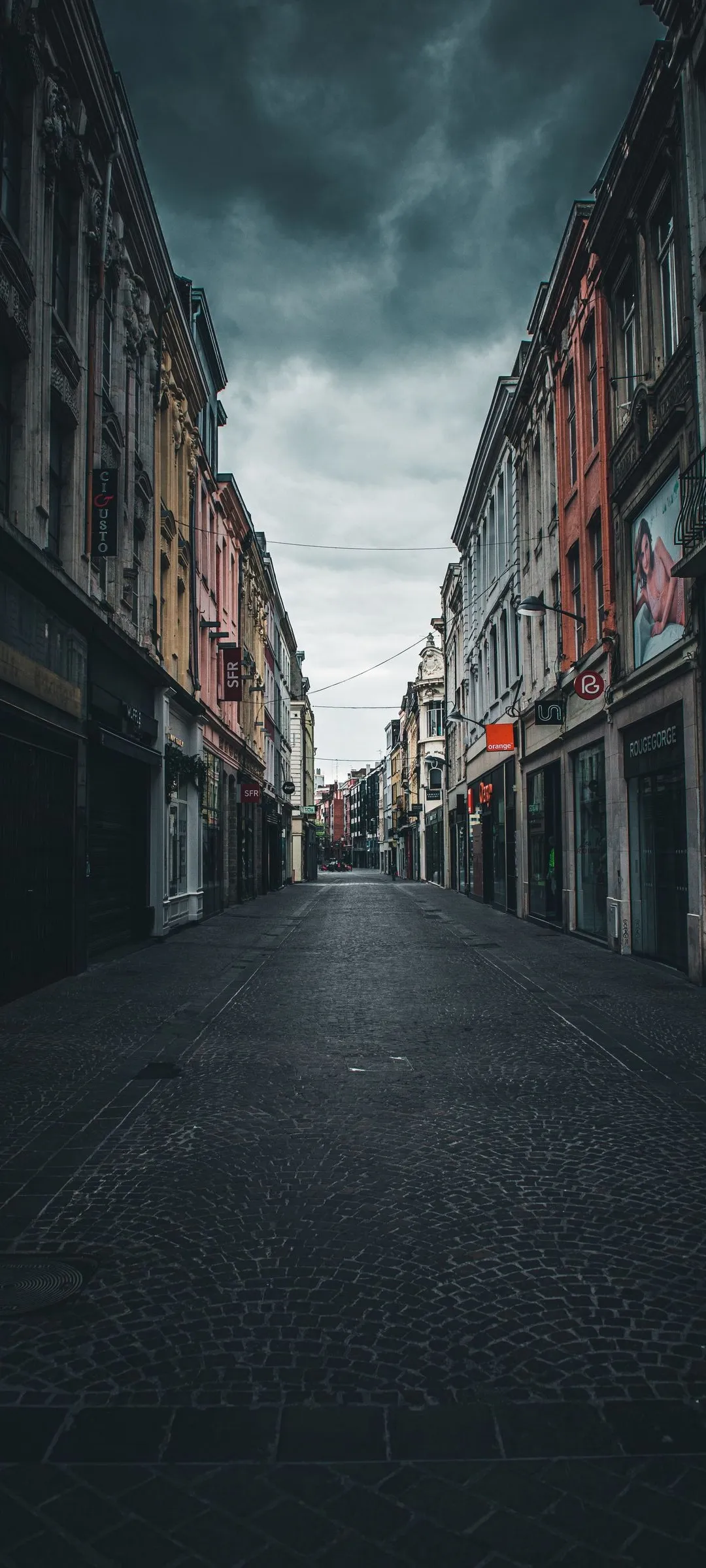Empty Narrow Street in Urban Town with Moody Lighting