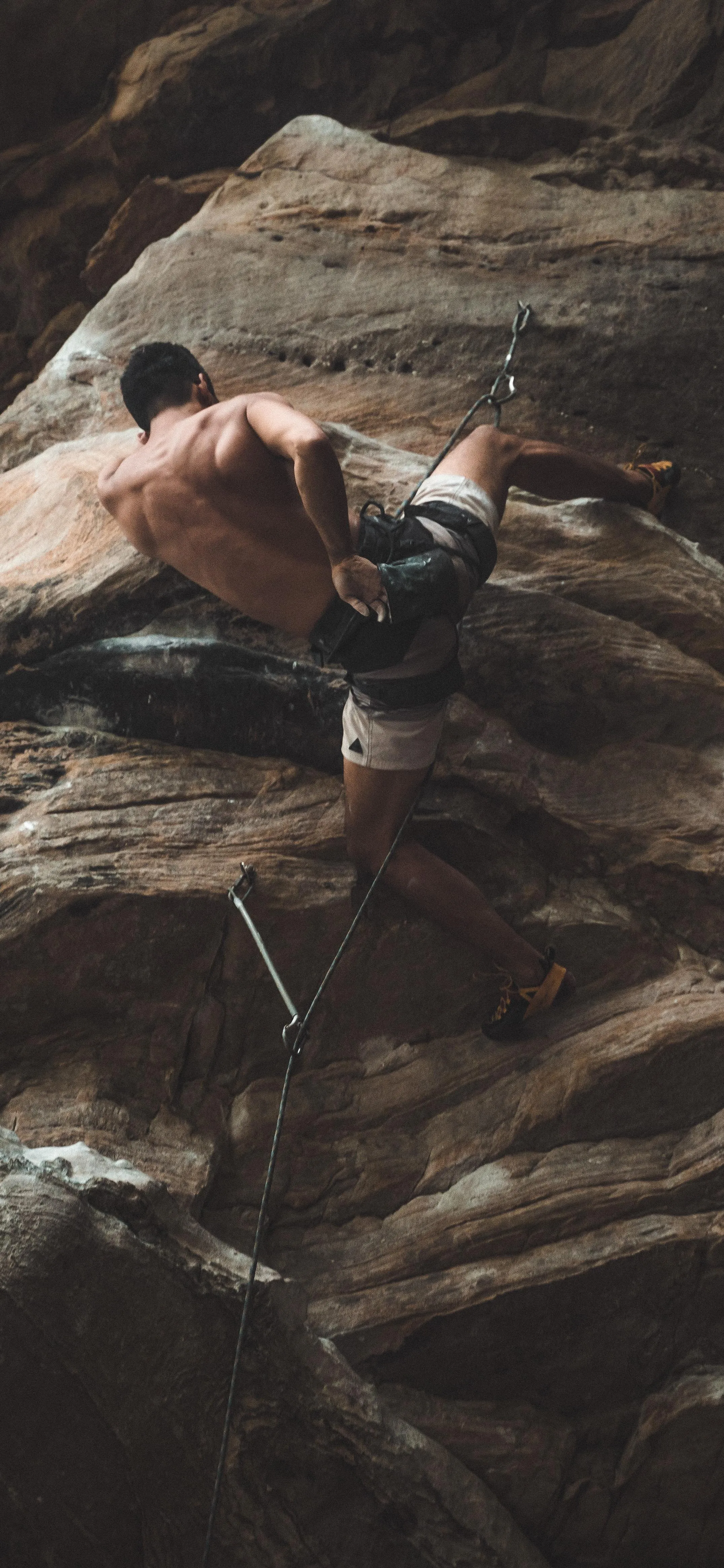 Experienced Rock Climber Scaling Steep Cliff Face Image