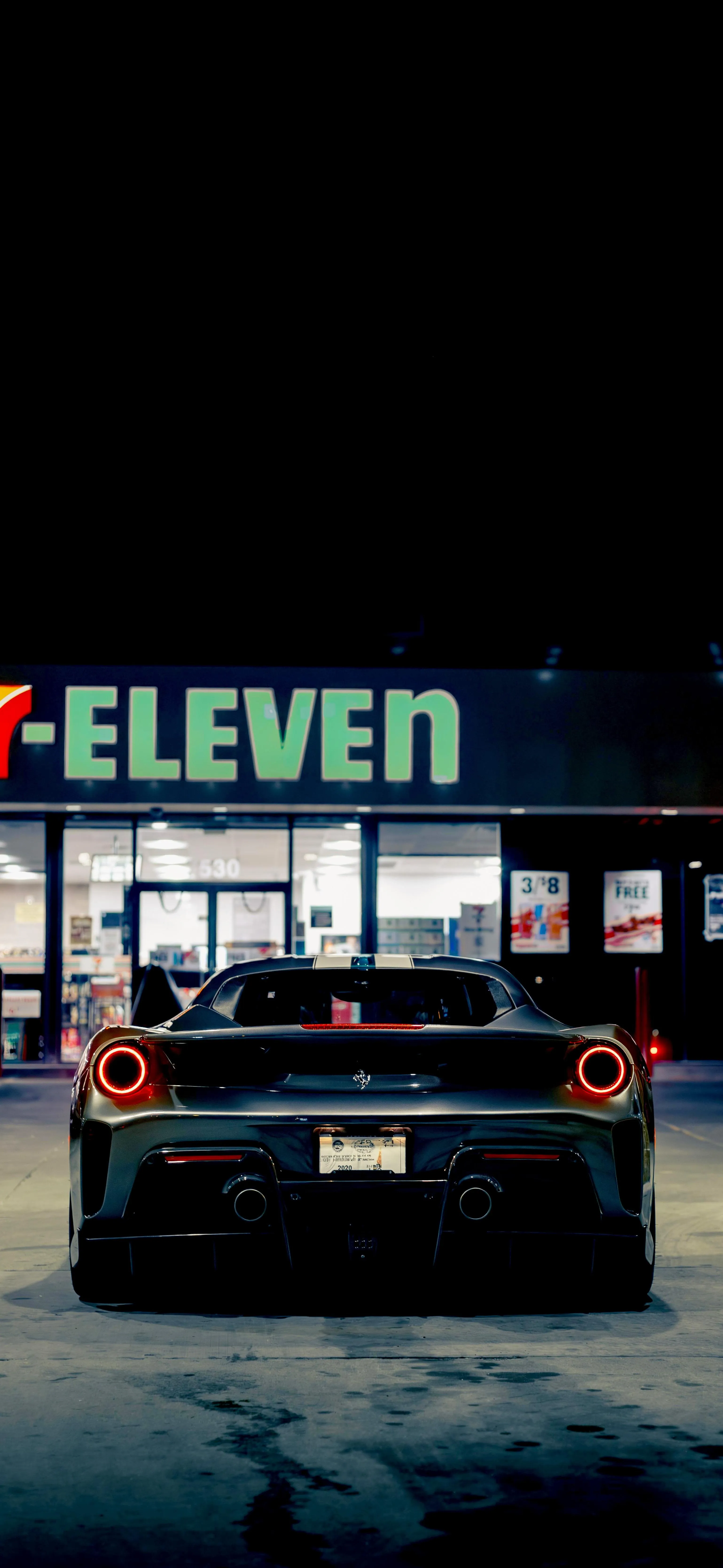 Ferrari Parked at Eleven Under Neon Lights at Night