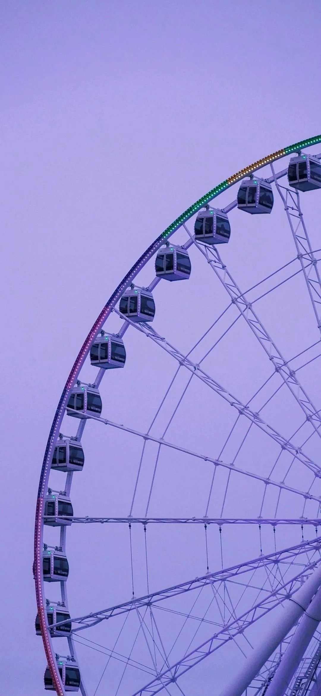 Ferris Wheel Rising above Skyline under Bright Sky