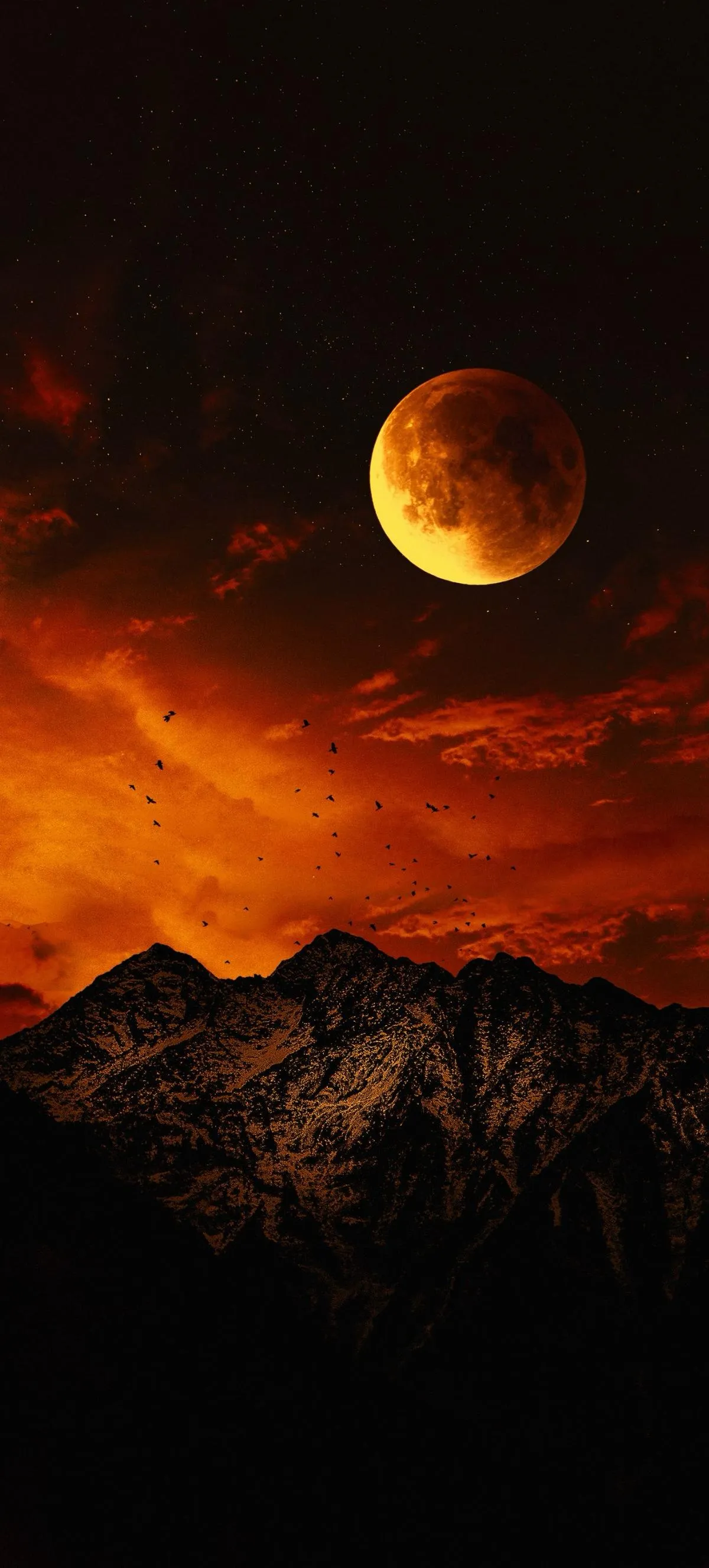 Fiery Moon Rising Behind Mountain Range at Night Wallpaper