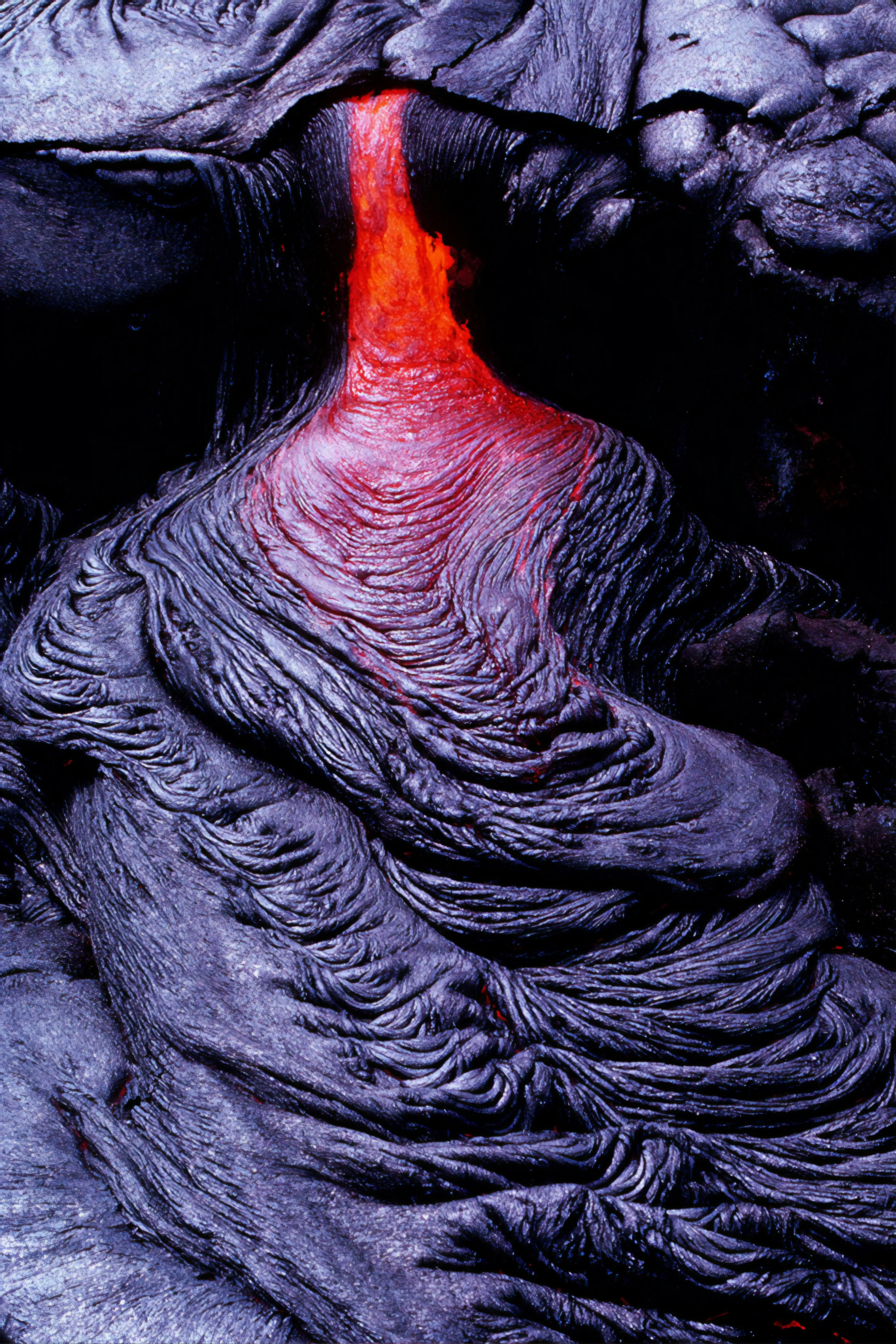 Flowing Lava Stream on Rugged Volcanic Surface Wallpaper