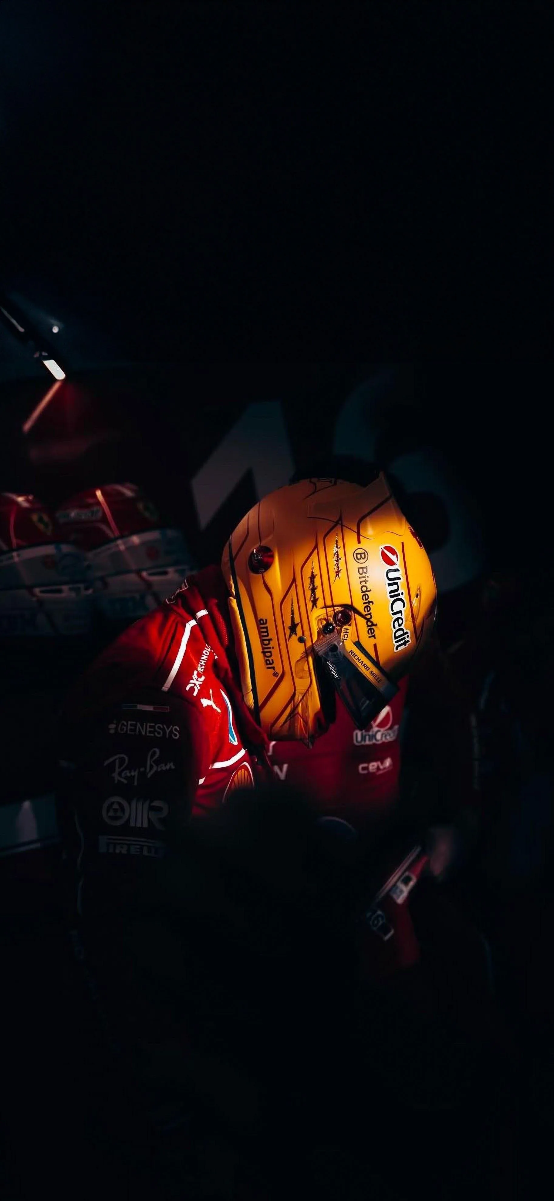 Formula One Driver Focused Before Race in Dark Pit Garage
