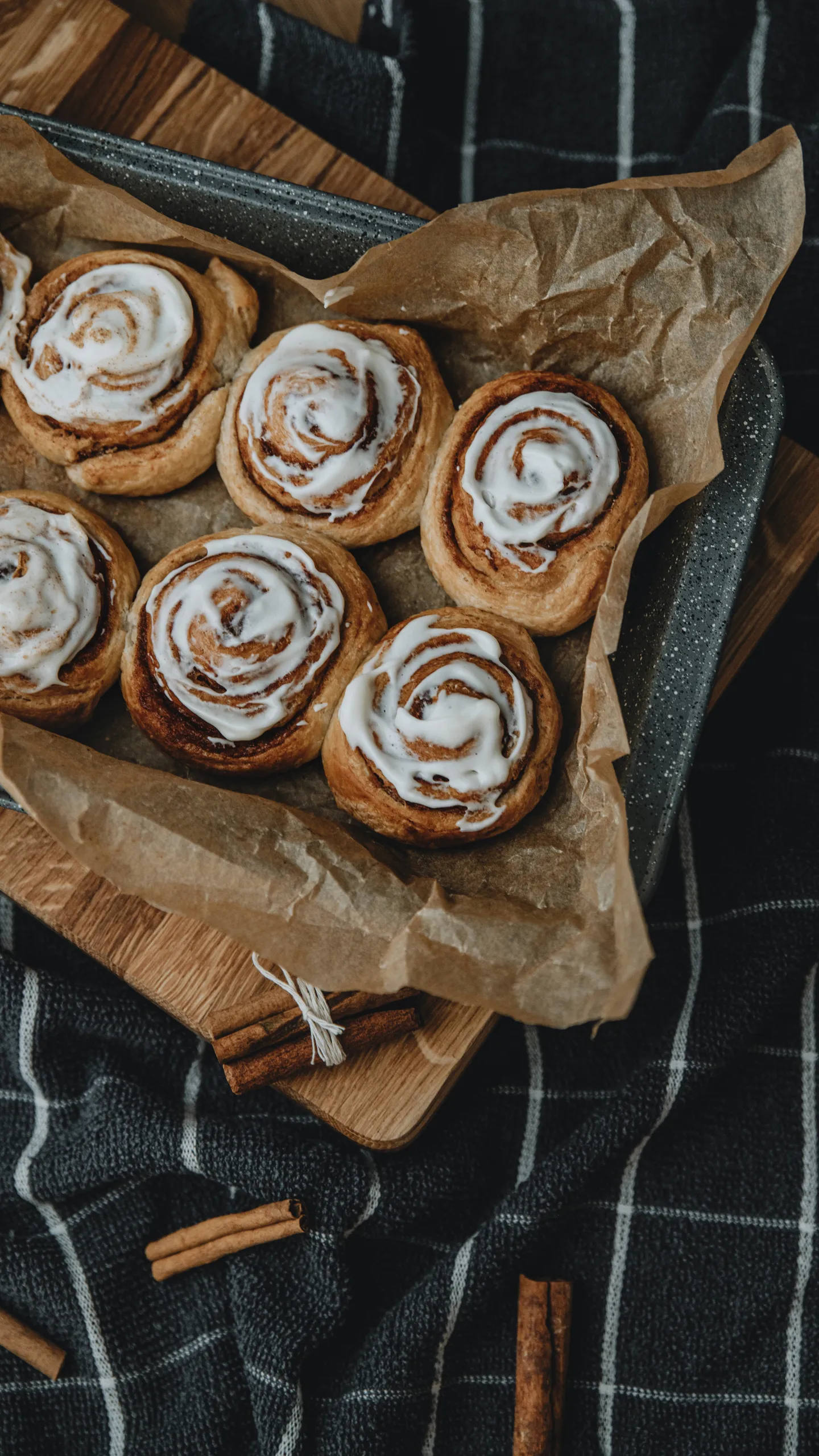 Freshly Baked Cinnamon Rolls Arranged on Rustic Wooden Board