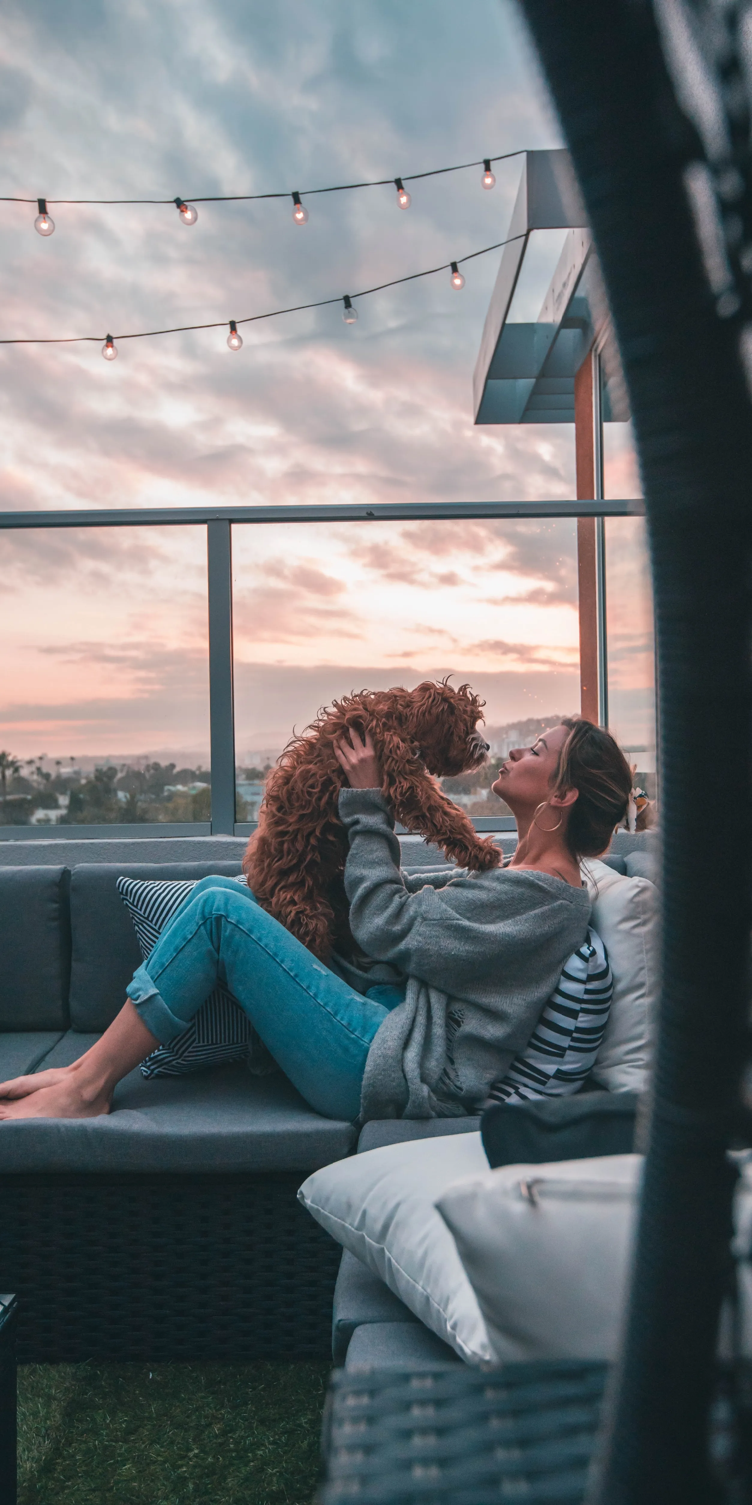 Girl with Dog Relaxing Together on Rooftop at Sunset 4K