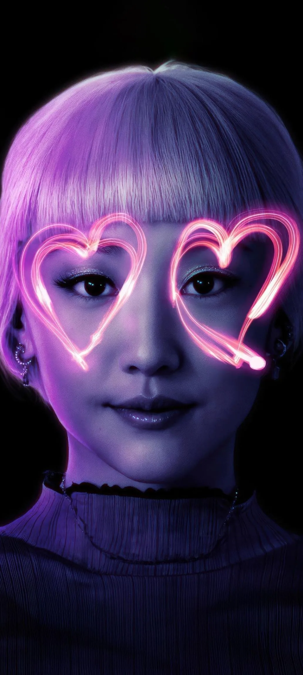 Girl With Glowing Neon Heart Glasses in Dark Room Wallpaper
