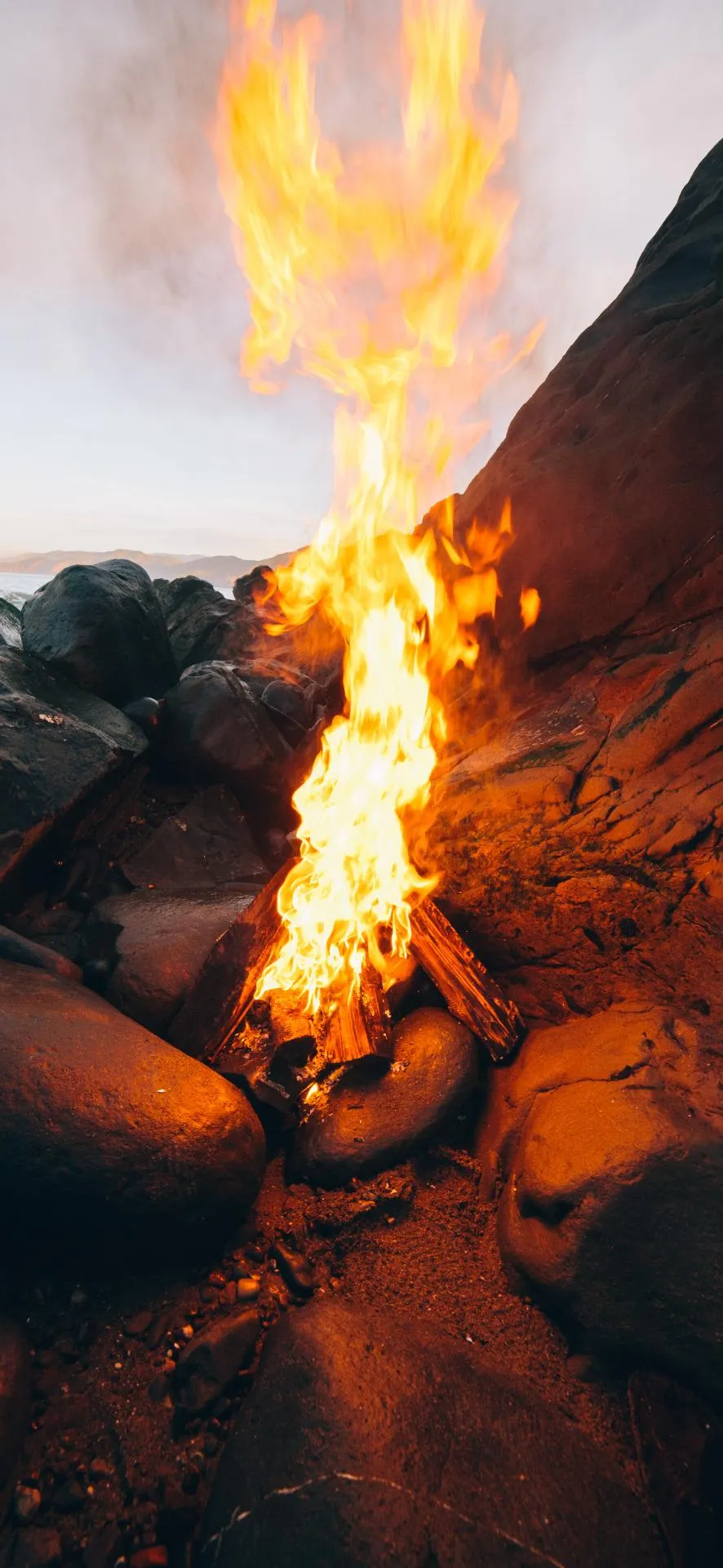 Glowing Campfire Scene Mobile Background at Night Wallpaper