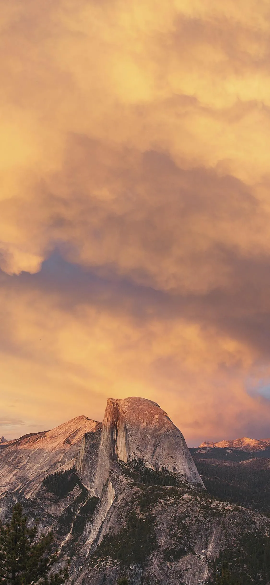 Glowing Sunset Behind Mountains with Soft Clouds Sky