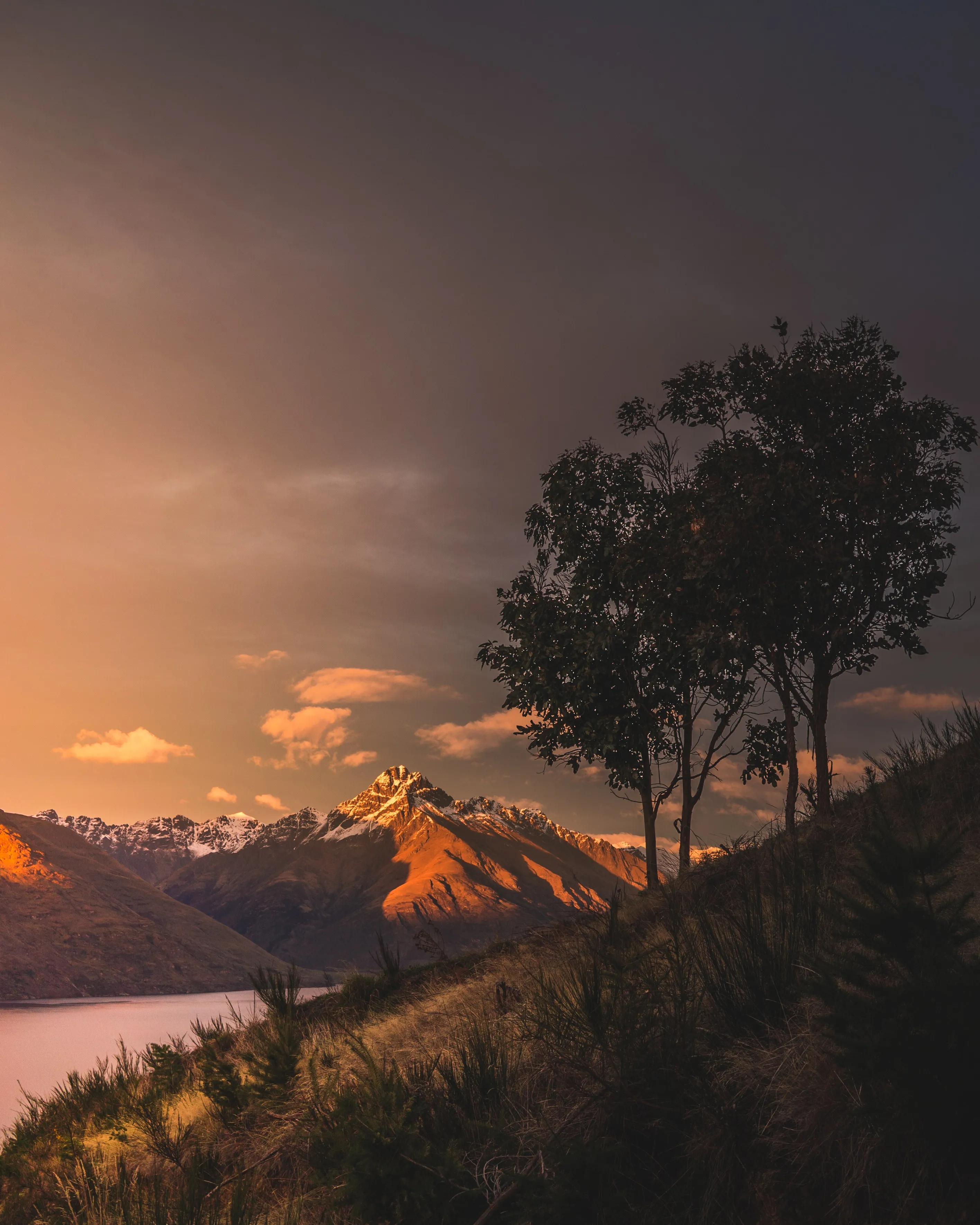 Golden Sunset Over Mountains with Peaceful Trees Wallpaper