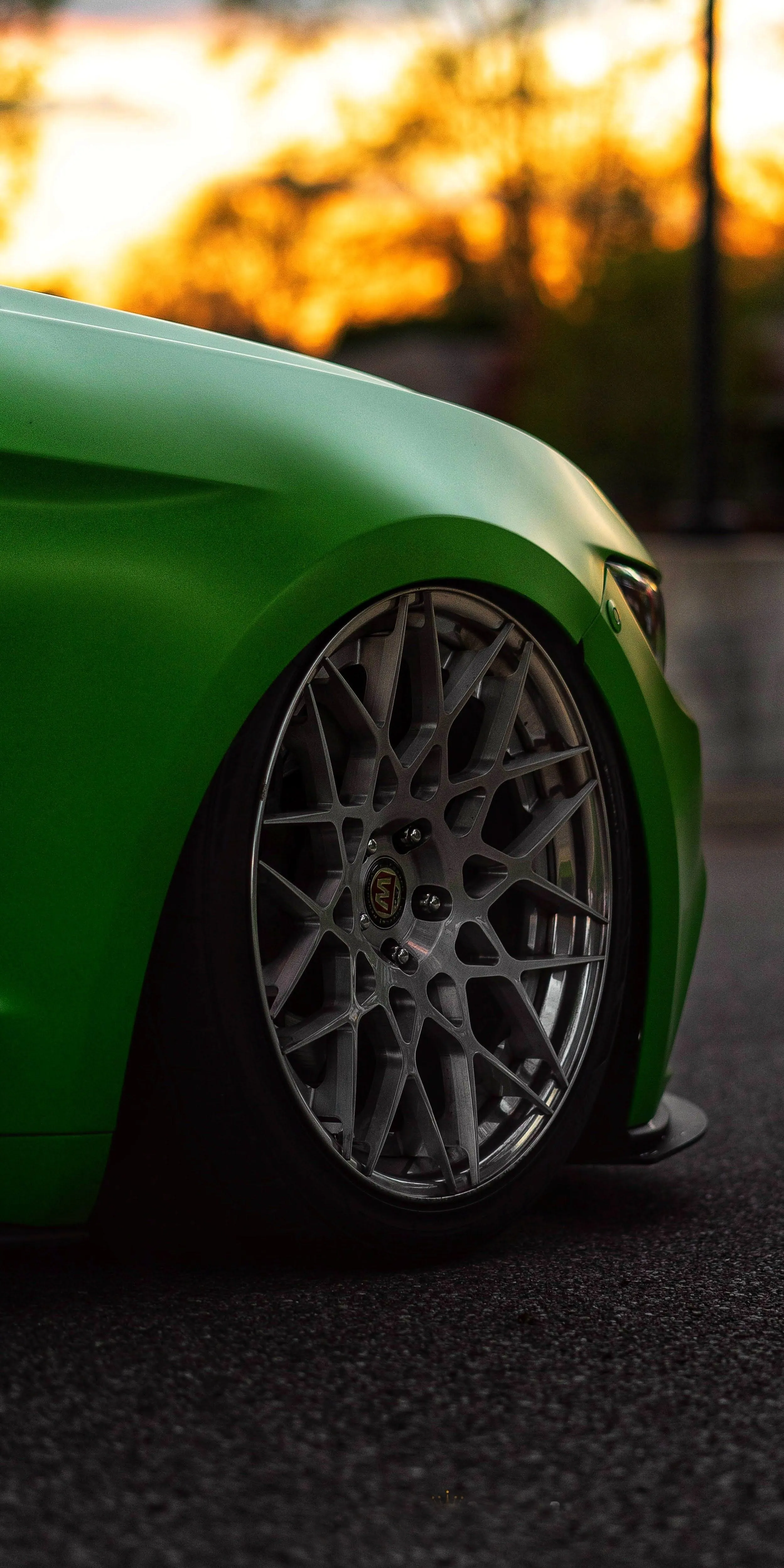 Green Sports Car Close Up Focused on Wheel and Fender