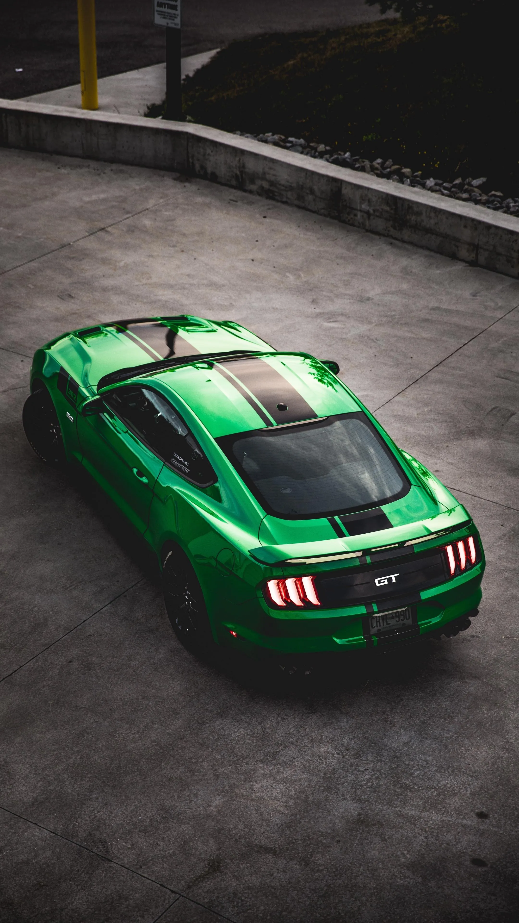 Green Sports Car Driving Through City at Night Wallpaper