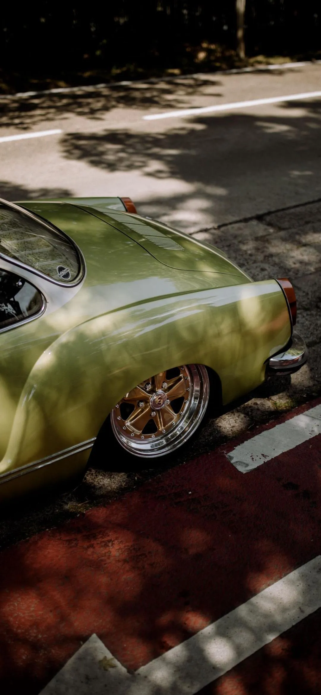 Green Sports Car Parked Under Soft Evening Light Wallpaper