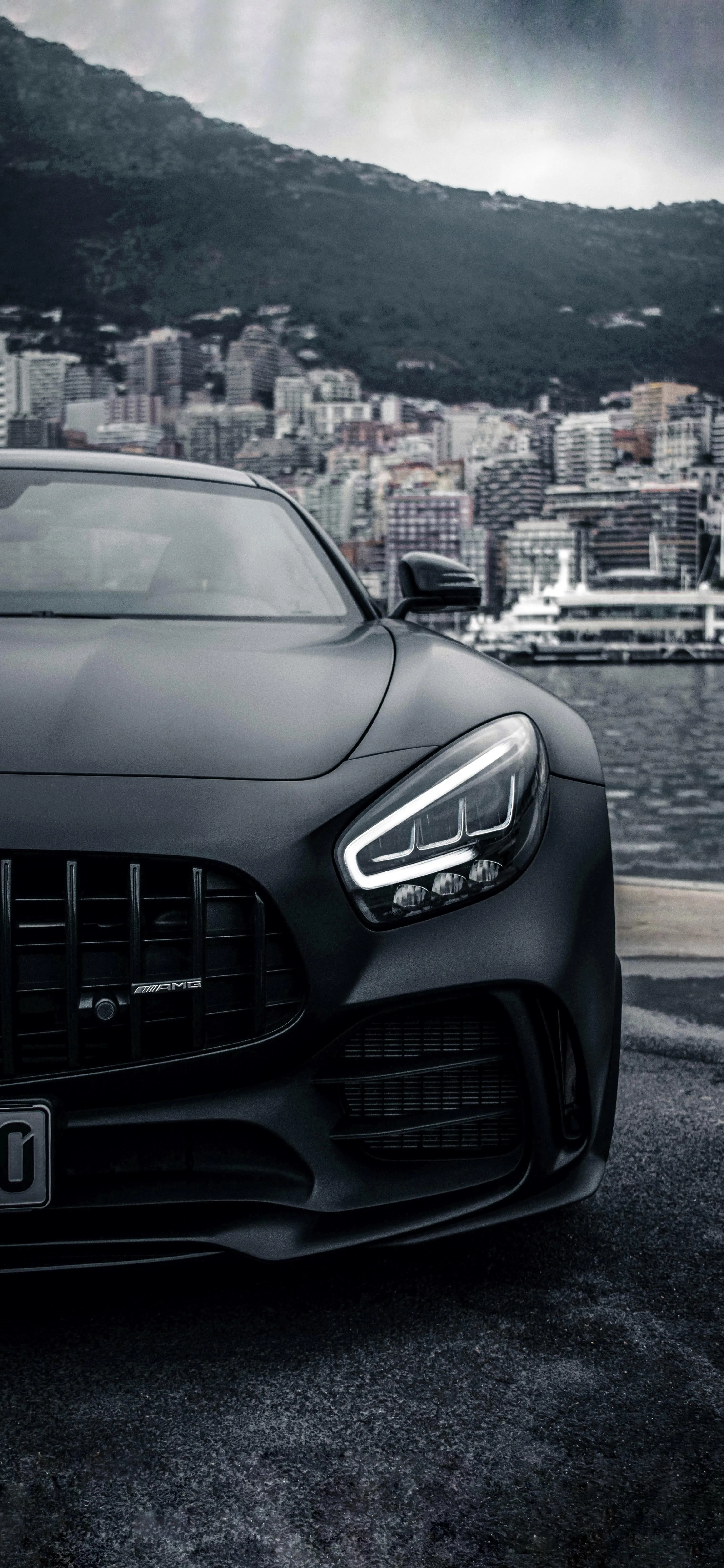 High End Sports Car Parked on City Street with Mountains