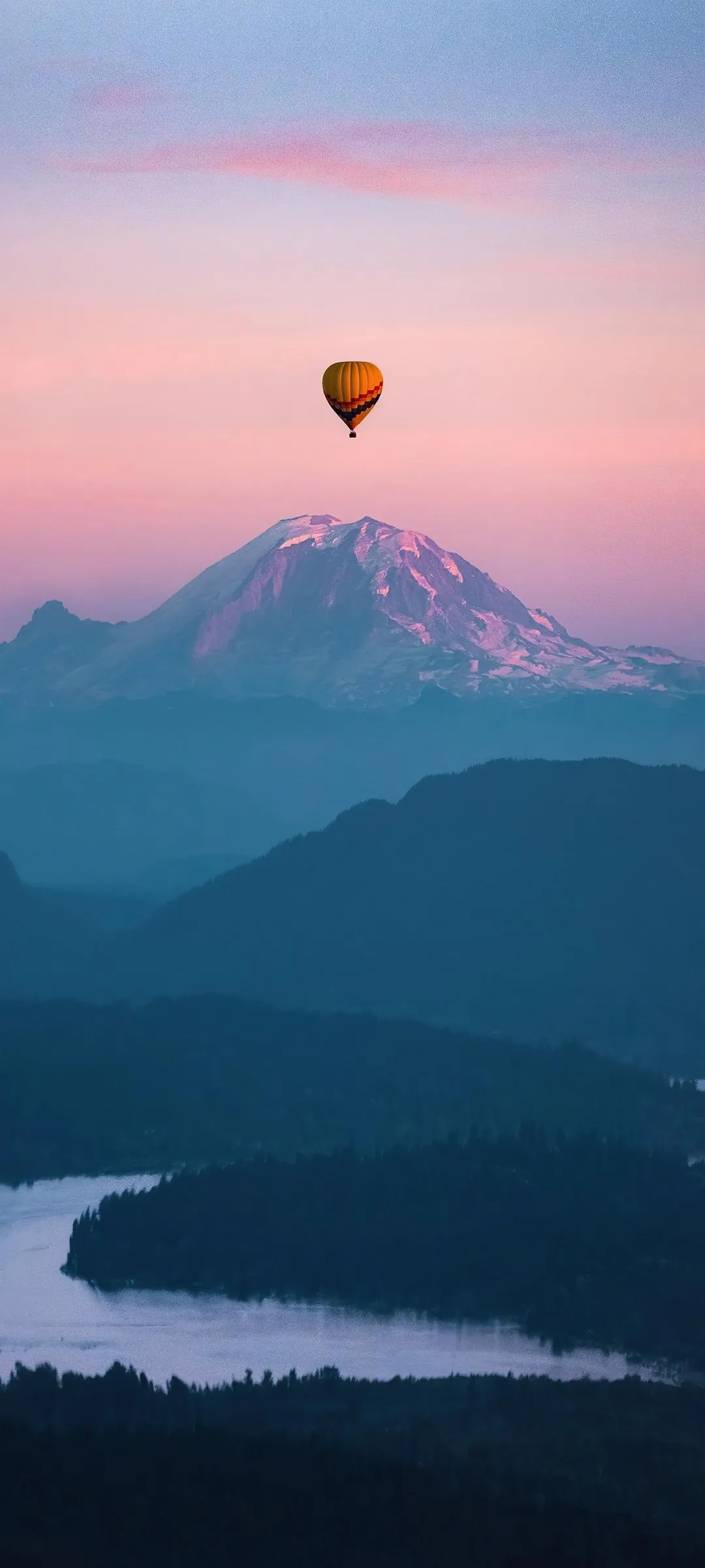 Hot Air Balloon Floating Over Mountain Valley Wallpaper