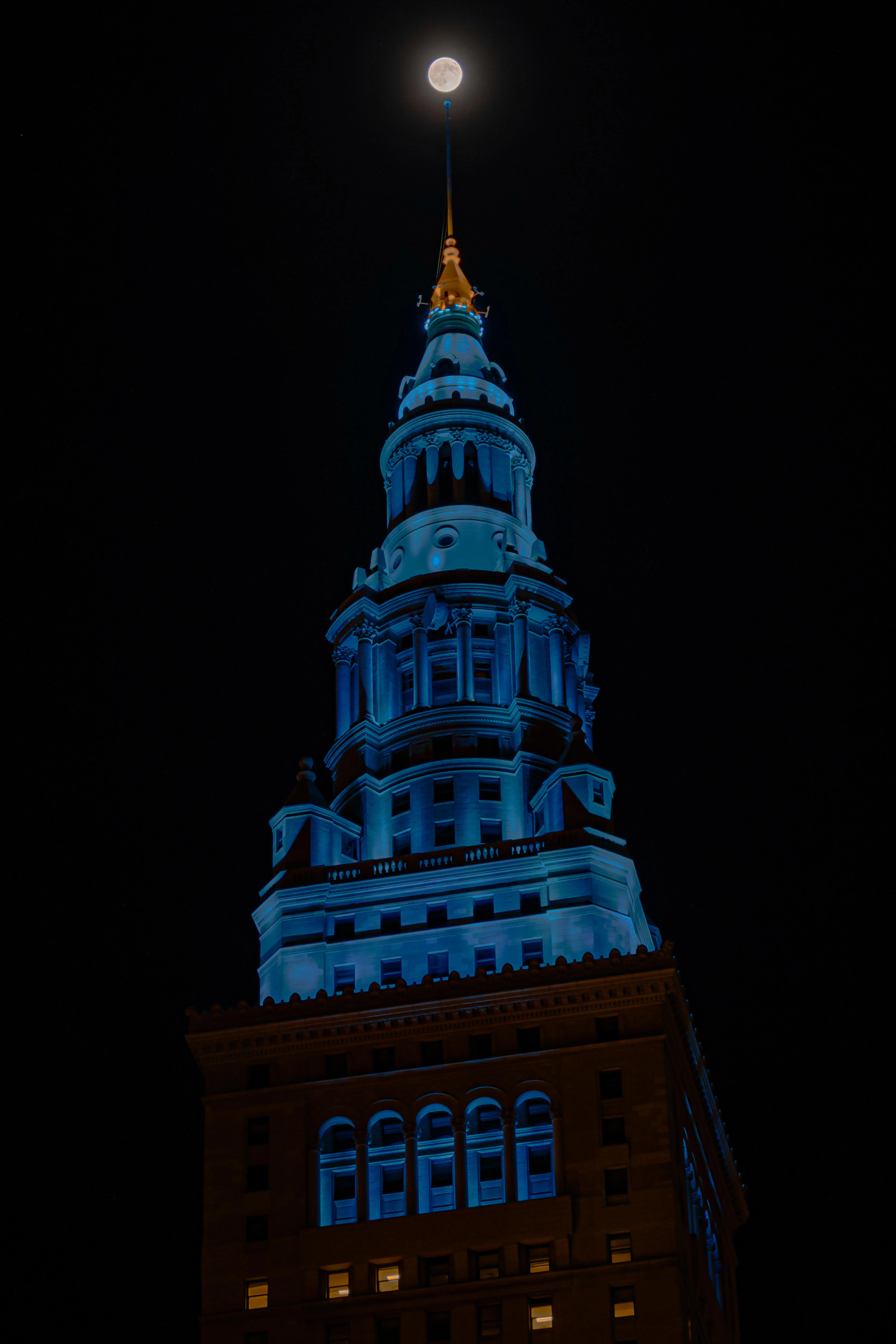 Iconic City Tower Illuminated in Blue Night Lights Wallpaper