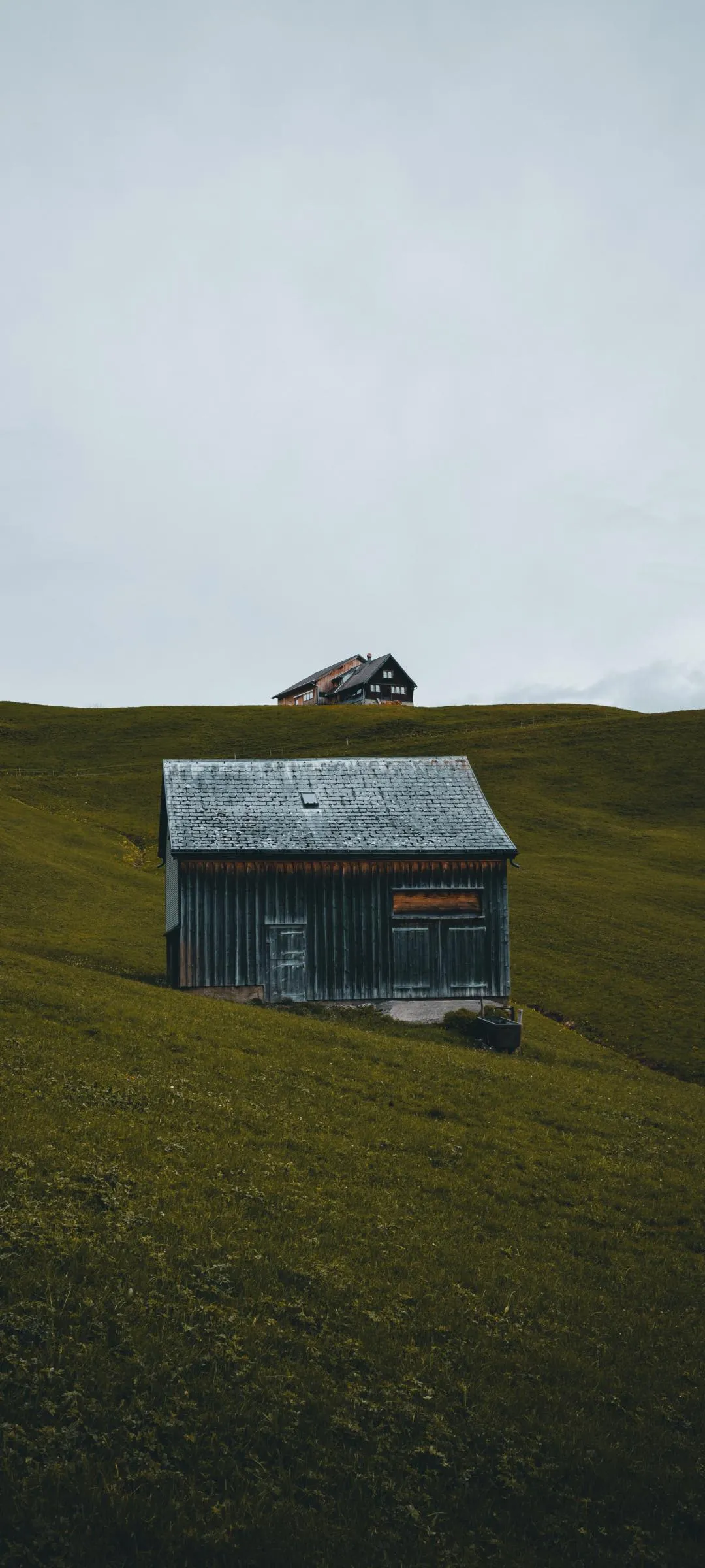 Isolated Old House on Green Hill under Cloudy Sky Wallpaper