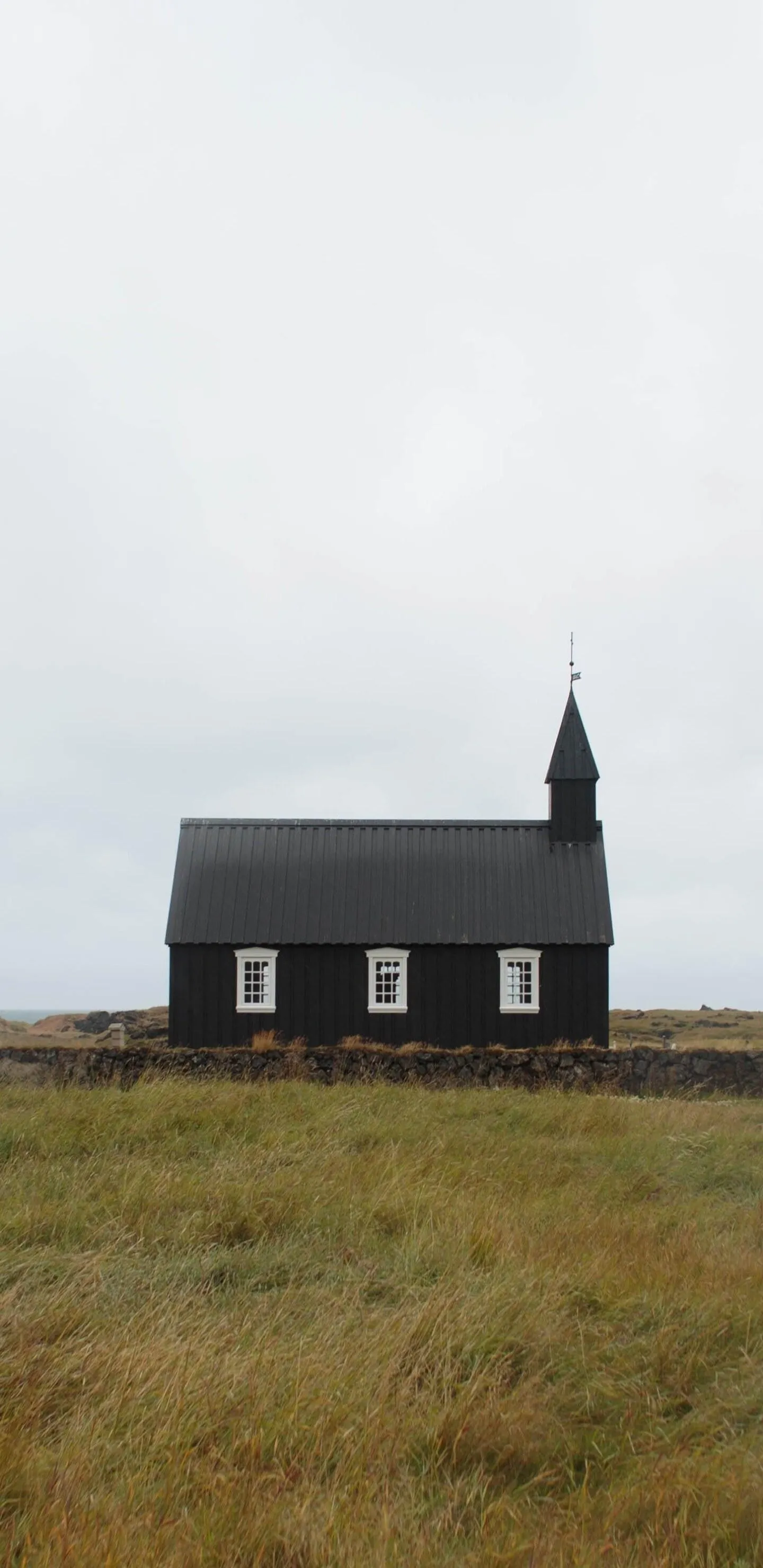 Isolated Small Church Standing In Foggy Empty Field