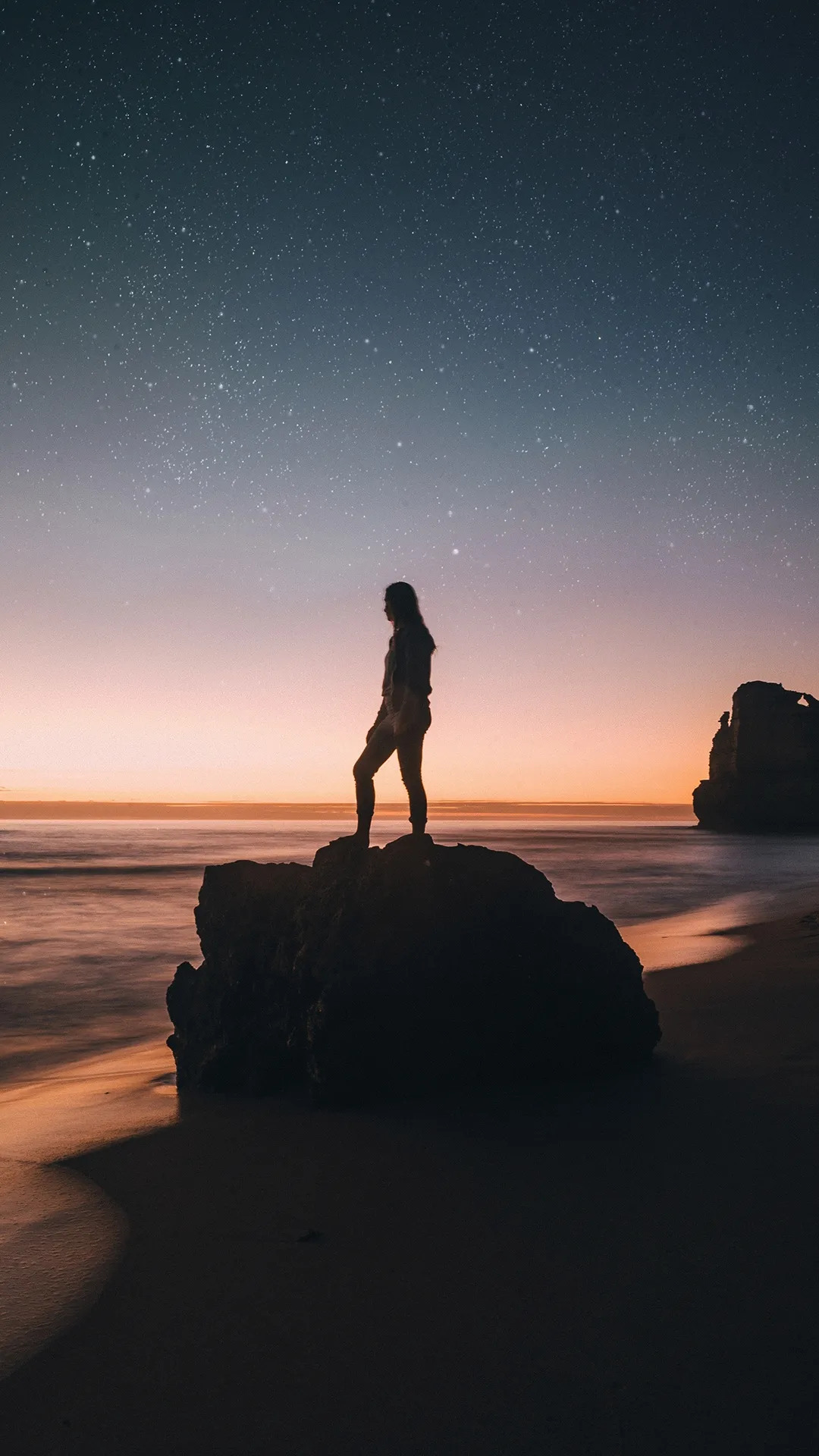 Lone Explorer Watching Sunset Over Serene Landscape