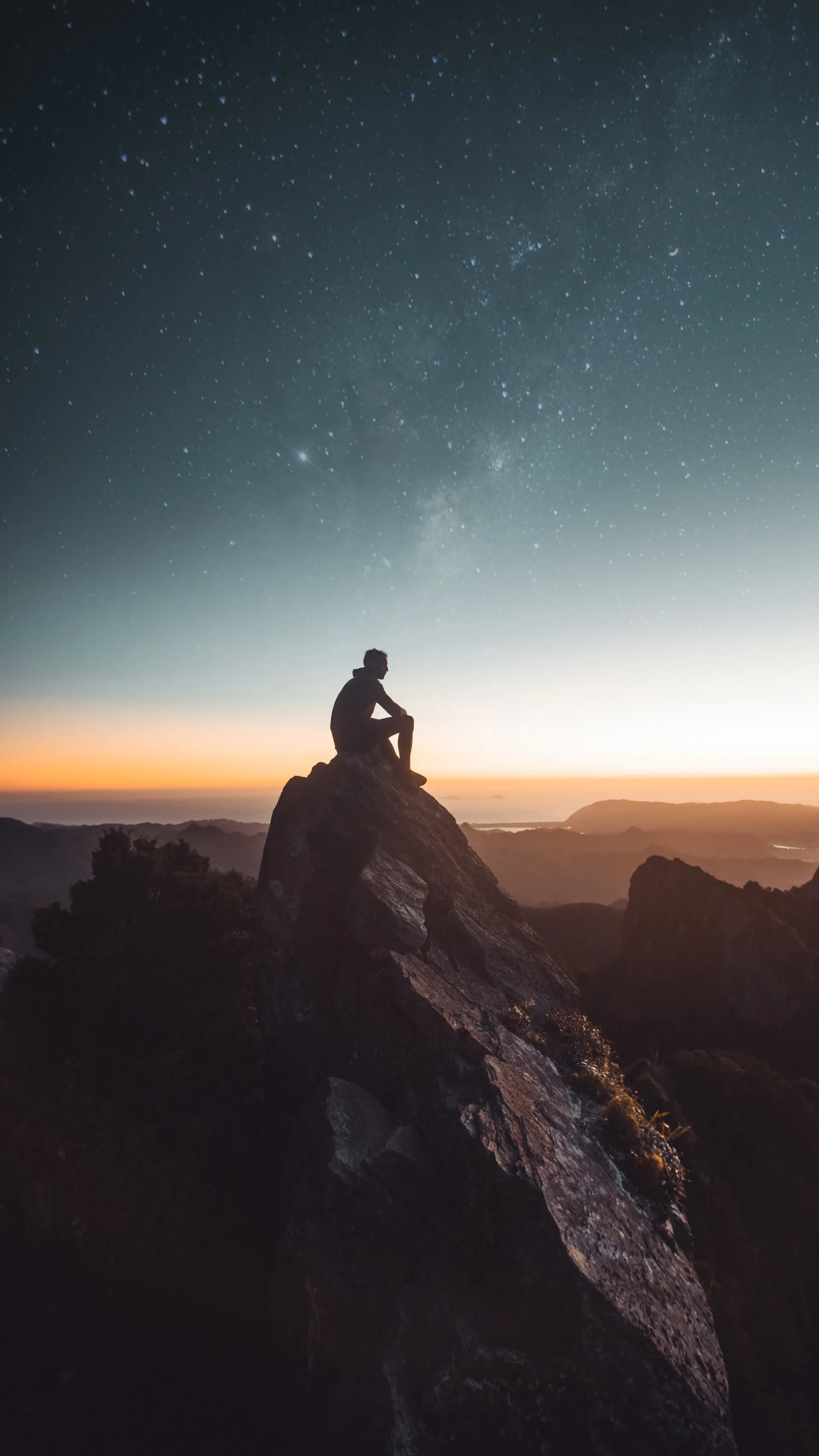 Lone Hiker on Mountain Peak at Golden Sunset Wallpaper