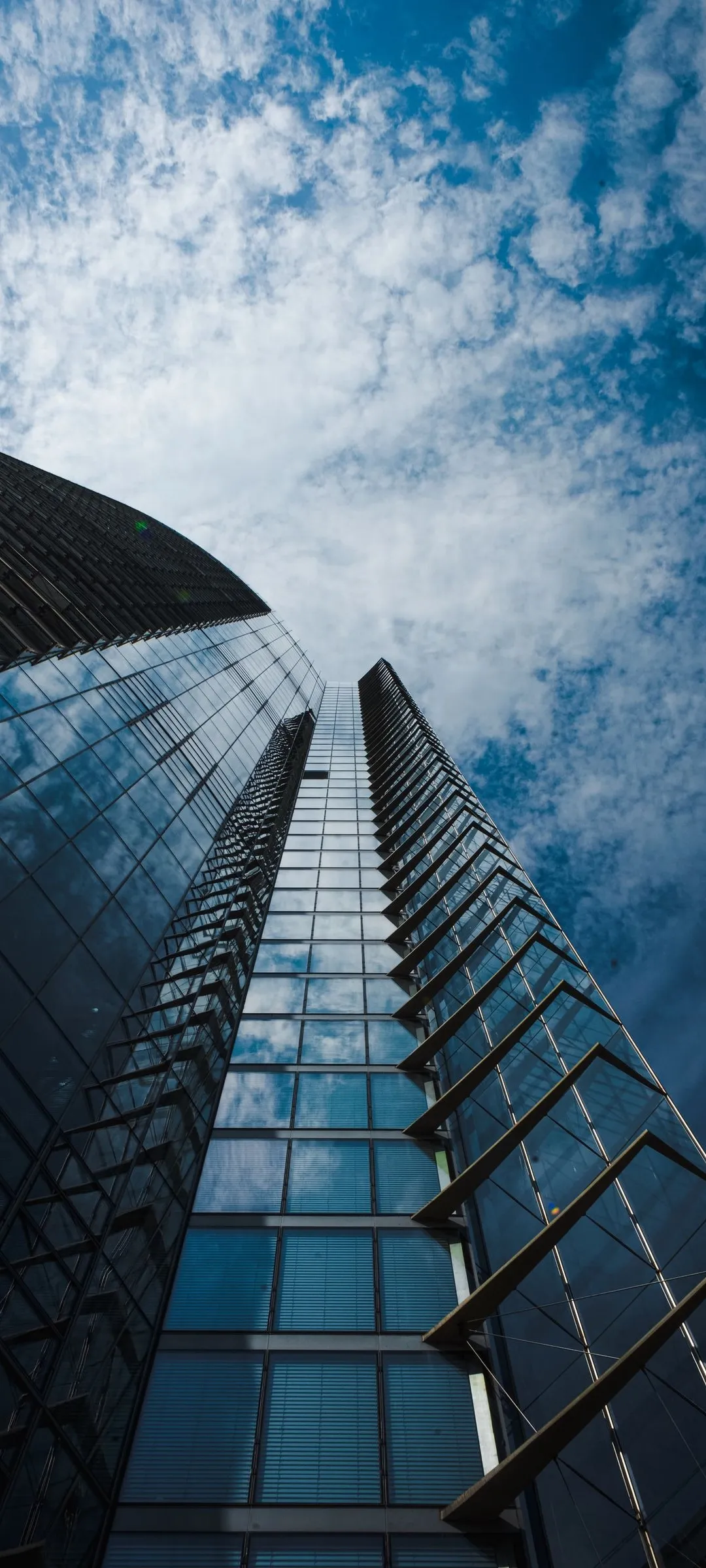 Looking Up at Modern Glass Skyscraper from Ground Level