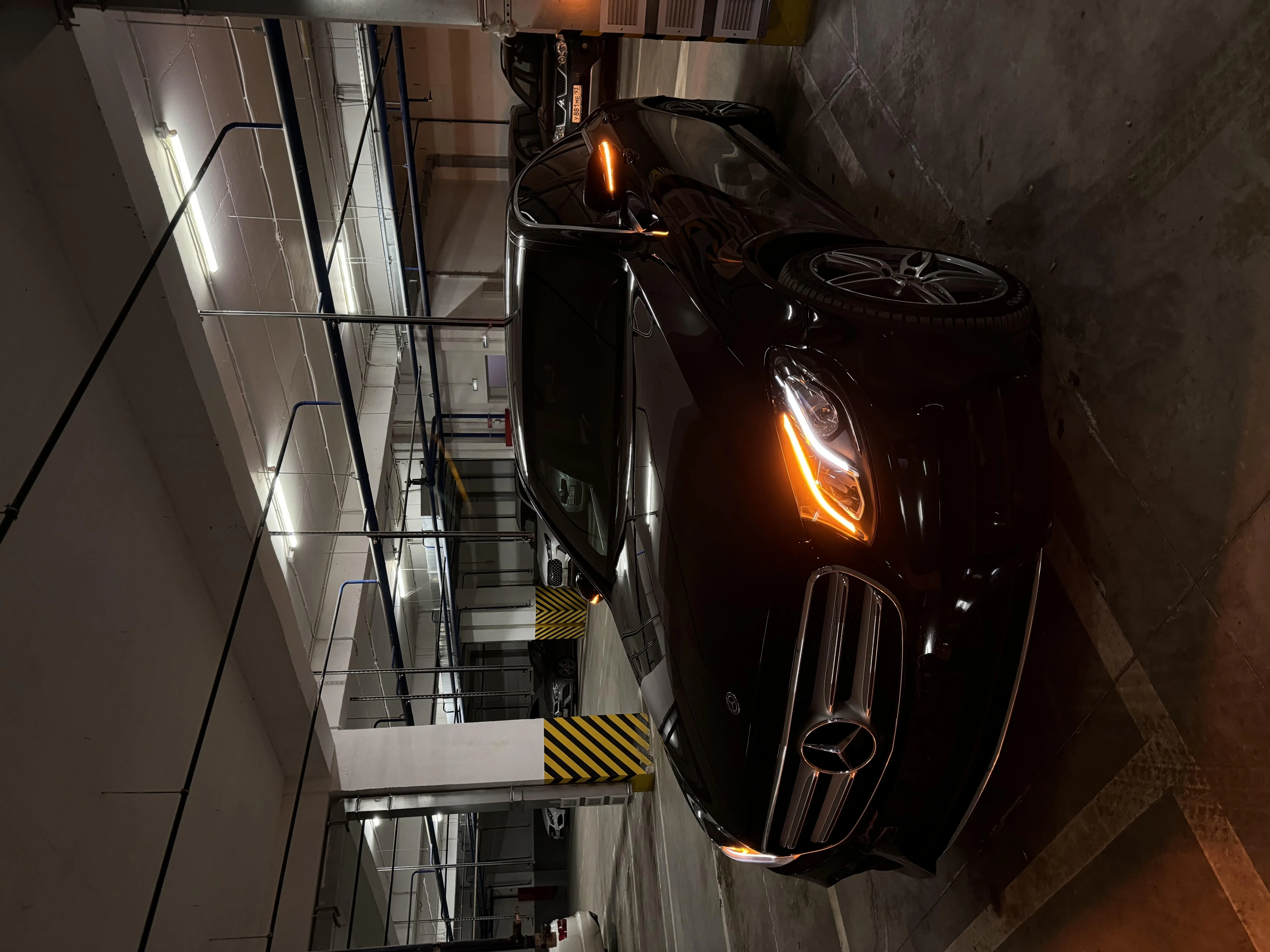Luxury Black Car in Underground Parking Area Wallpaper