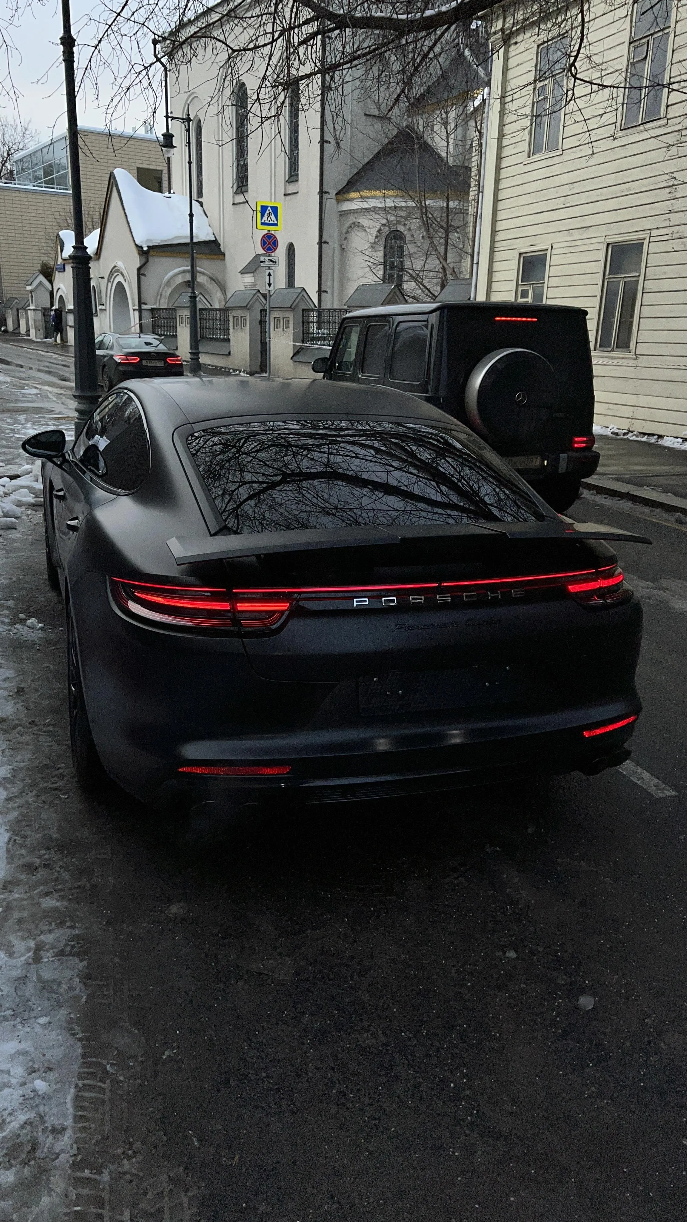 Luxury Black Sports Car Parked in Urban Alleyway Image