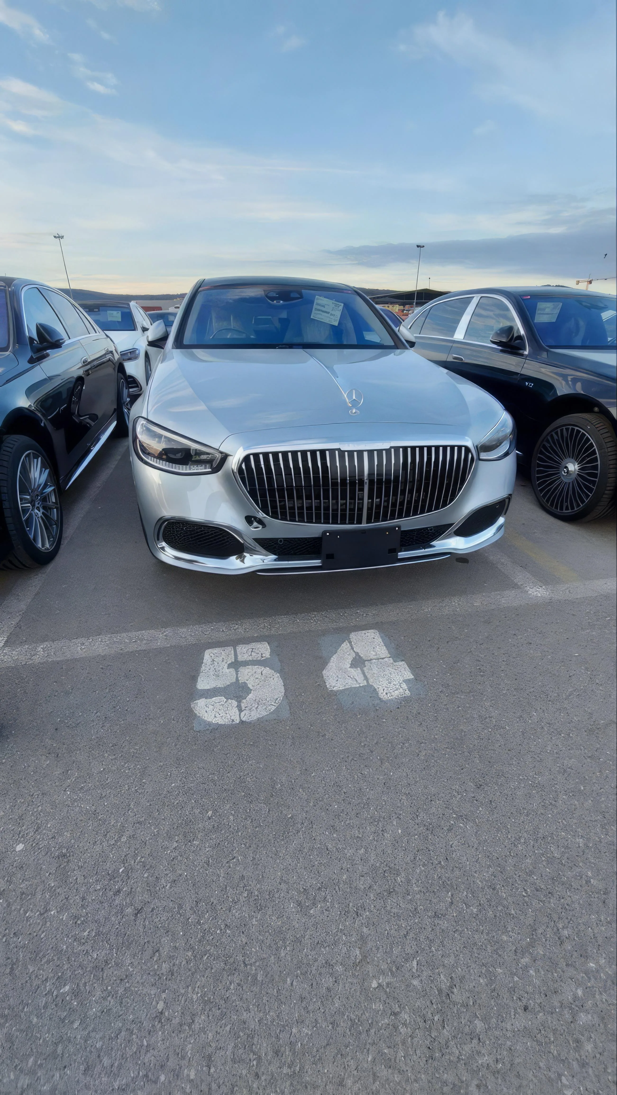 Luxury Car Parked in an Outdoor Lot with Clear Sky Wallpaper