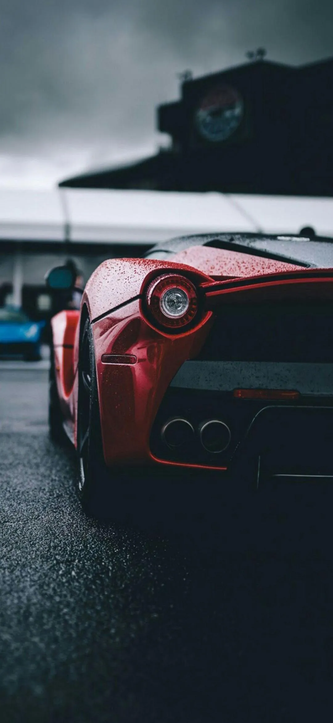 Luxury Red Sports Car on Wet Street Night Scene Wallpaper