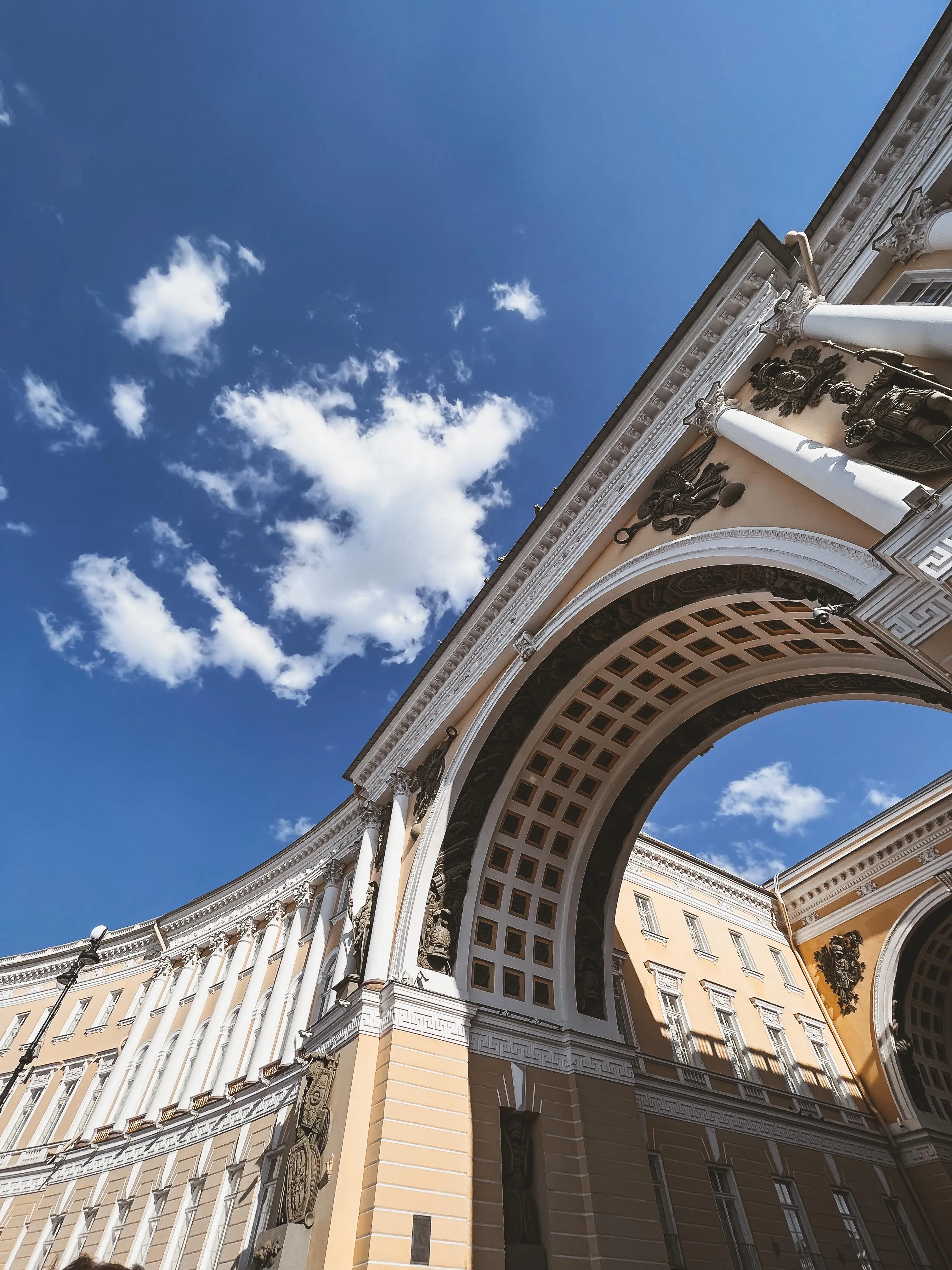 Majestic Arch and Historic Building Under a Sunny Sky
