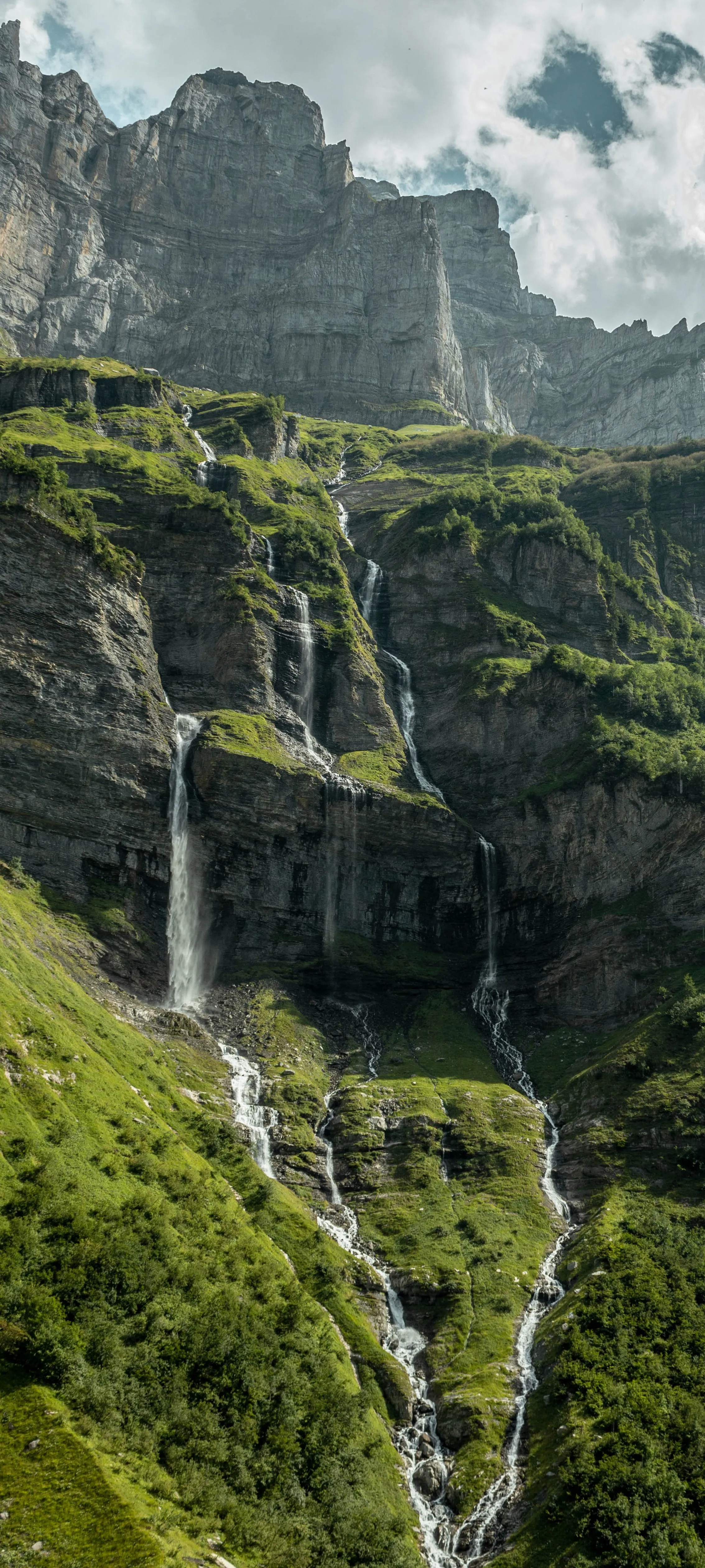 Majestic Green Waterfall in Mountain Landscape Wallpaper