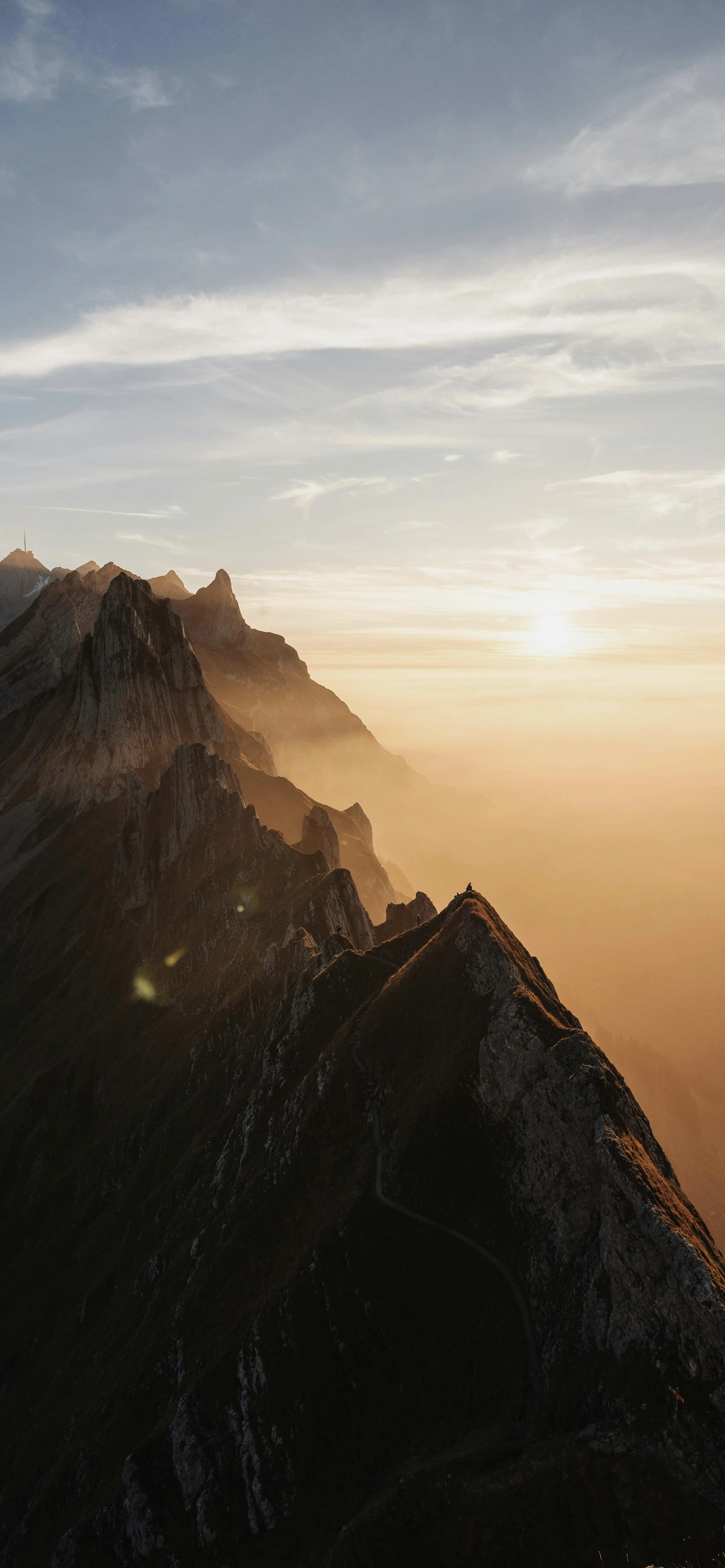 Majestic Mountain Peaks Under Golden Hour Light Image