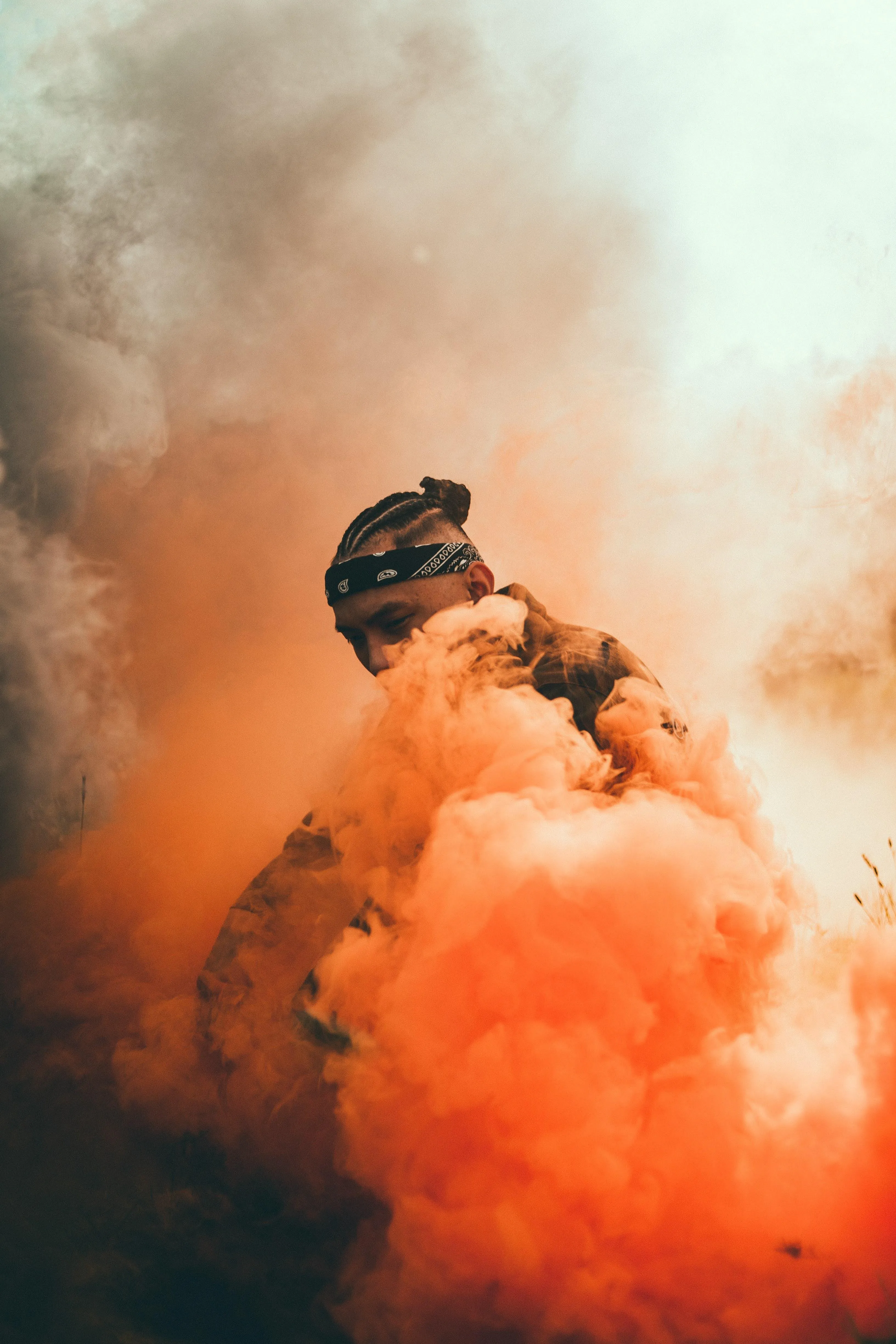 Man Covered in Orange Smoke with Dramatic Contrast Wallpaper