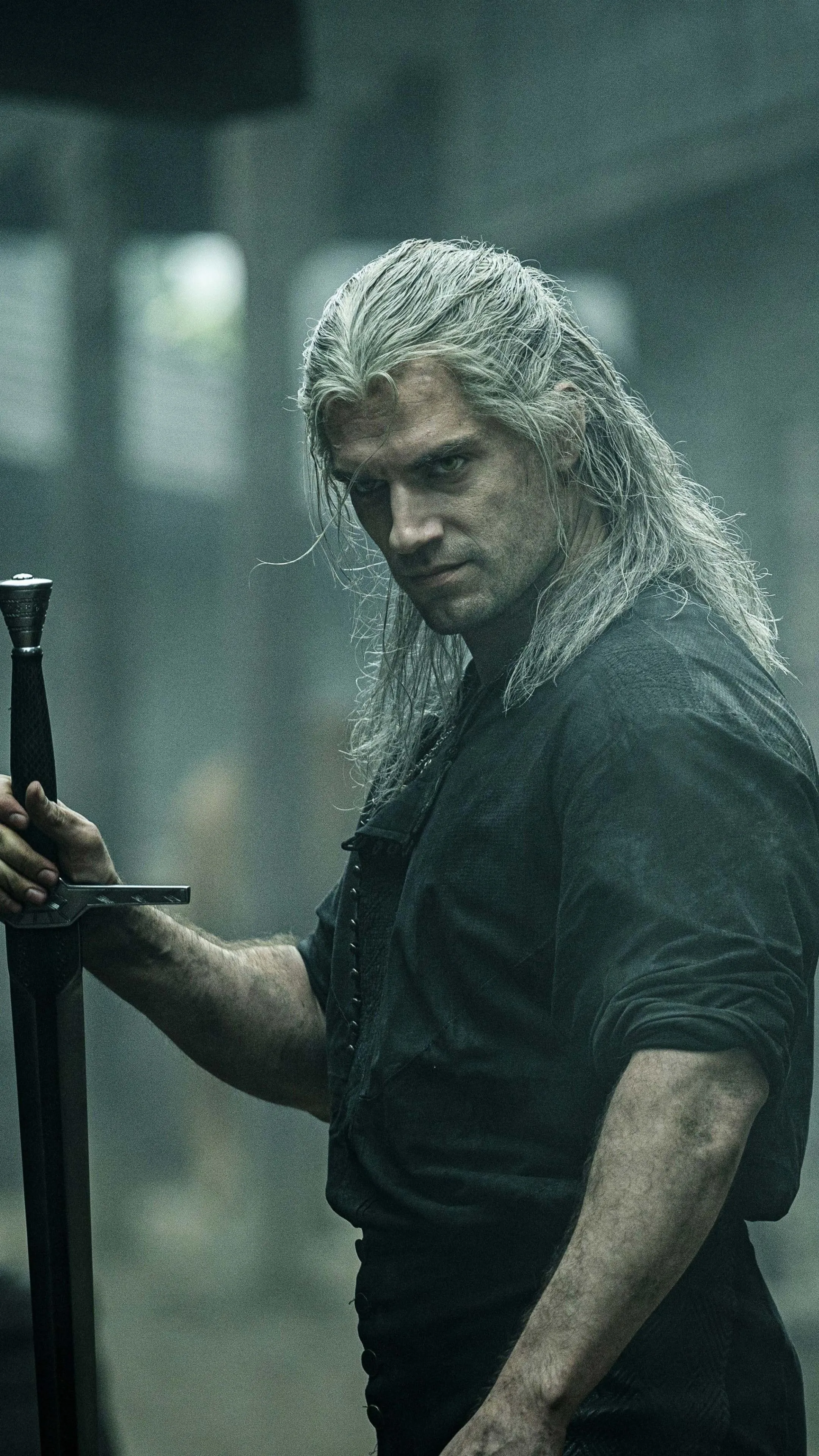 Man Holding a Weapon While Standing in a Dark Room