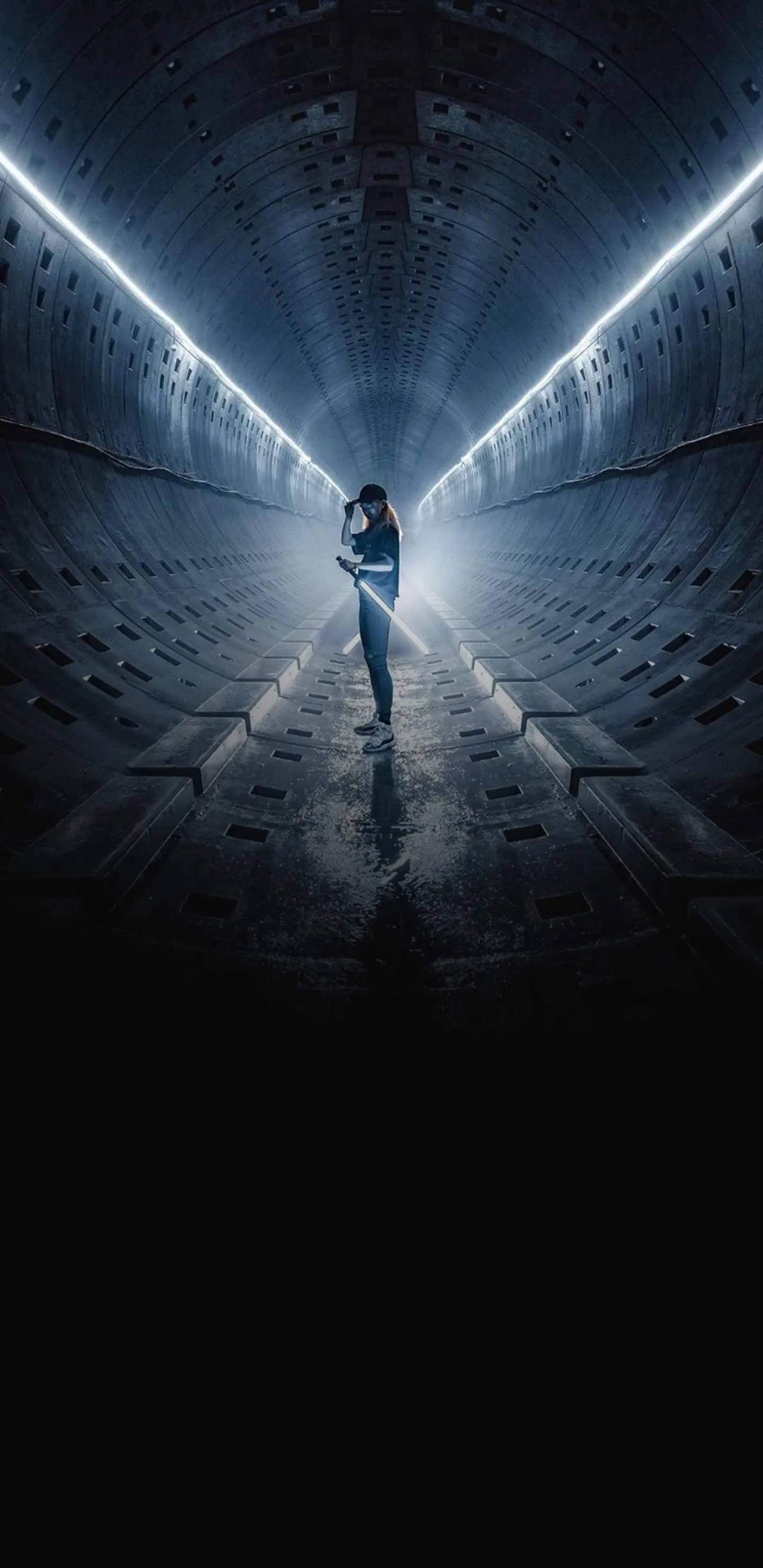 Man Holding Sword Standing in a Futuristic Tunnel image
