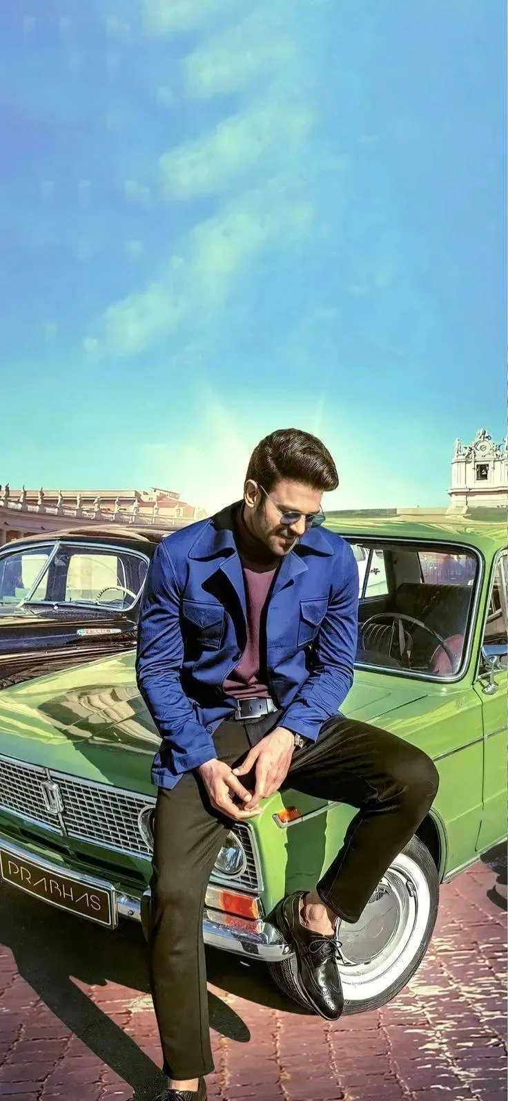 Man Sitting on Car Parked on Open Green Field Wallpaper