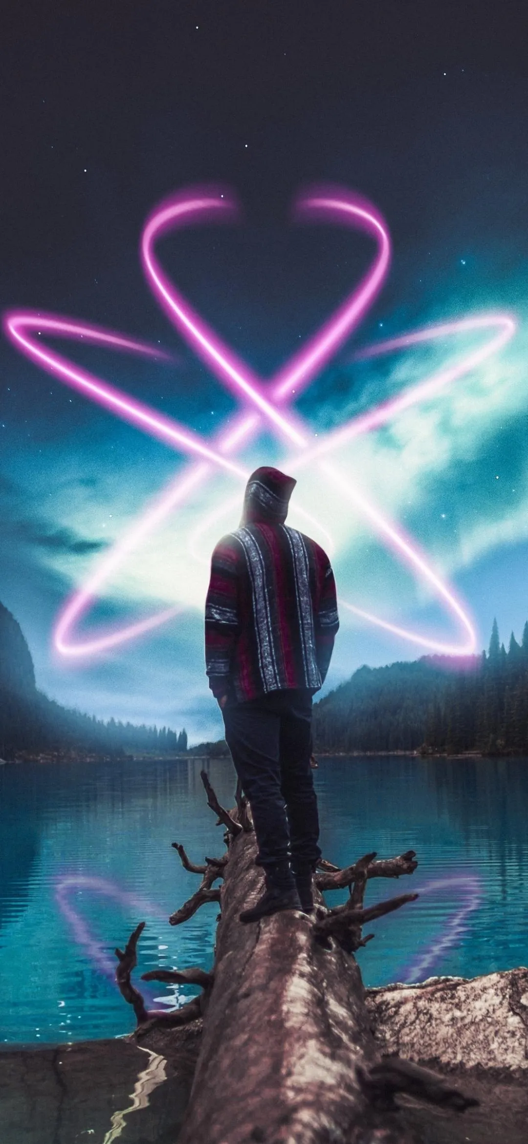 Man Standing On Mountain Peak Holding Heart Shape Light