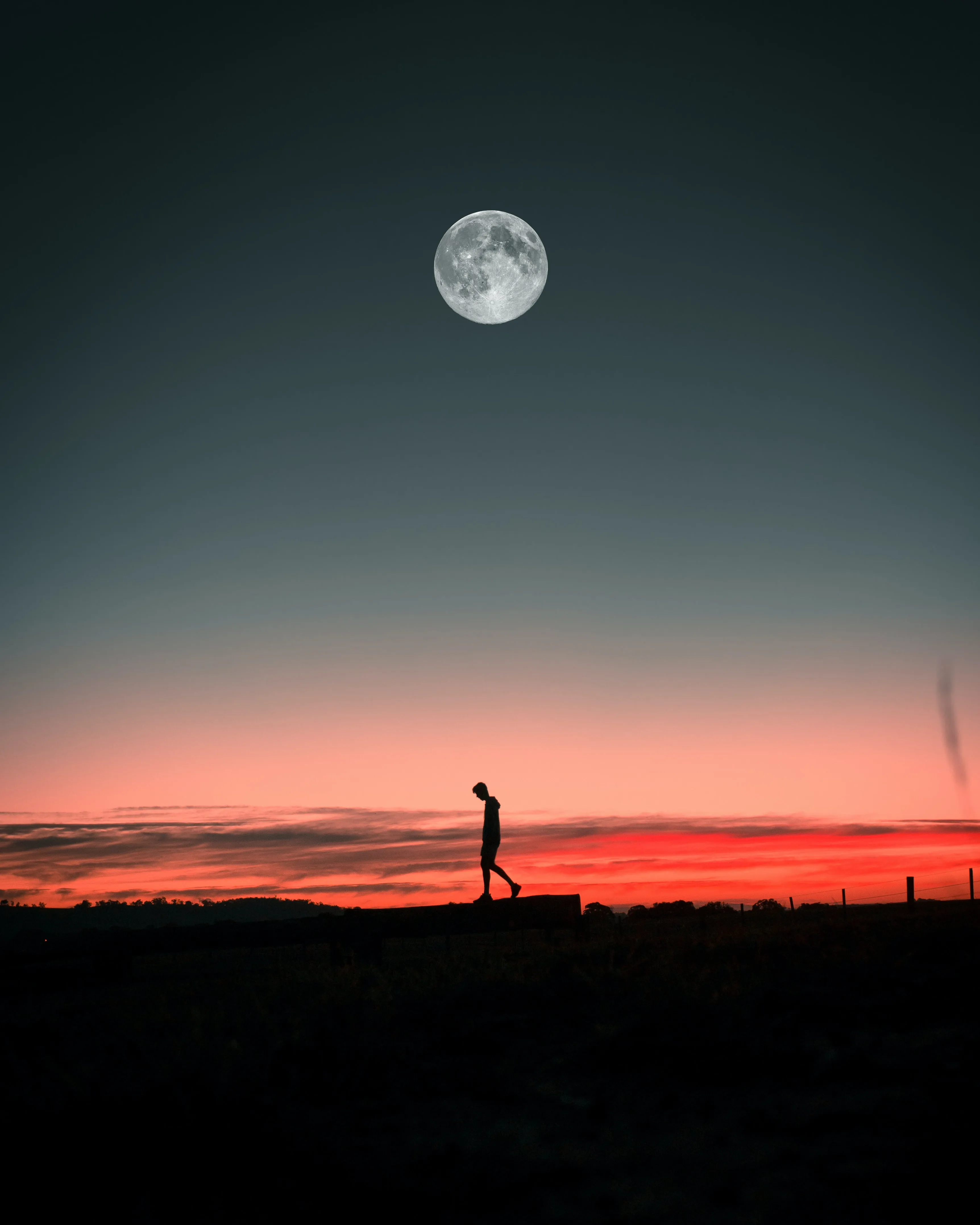 Man Walking Under Moonlight for iPhone 14 Pro Wallpaper