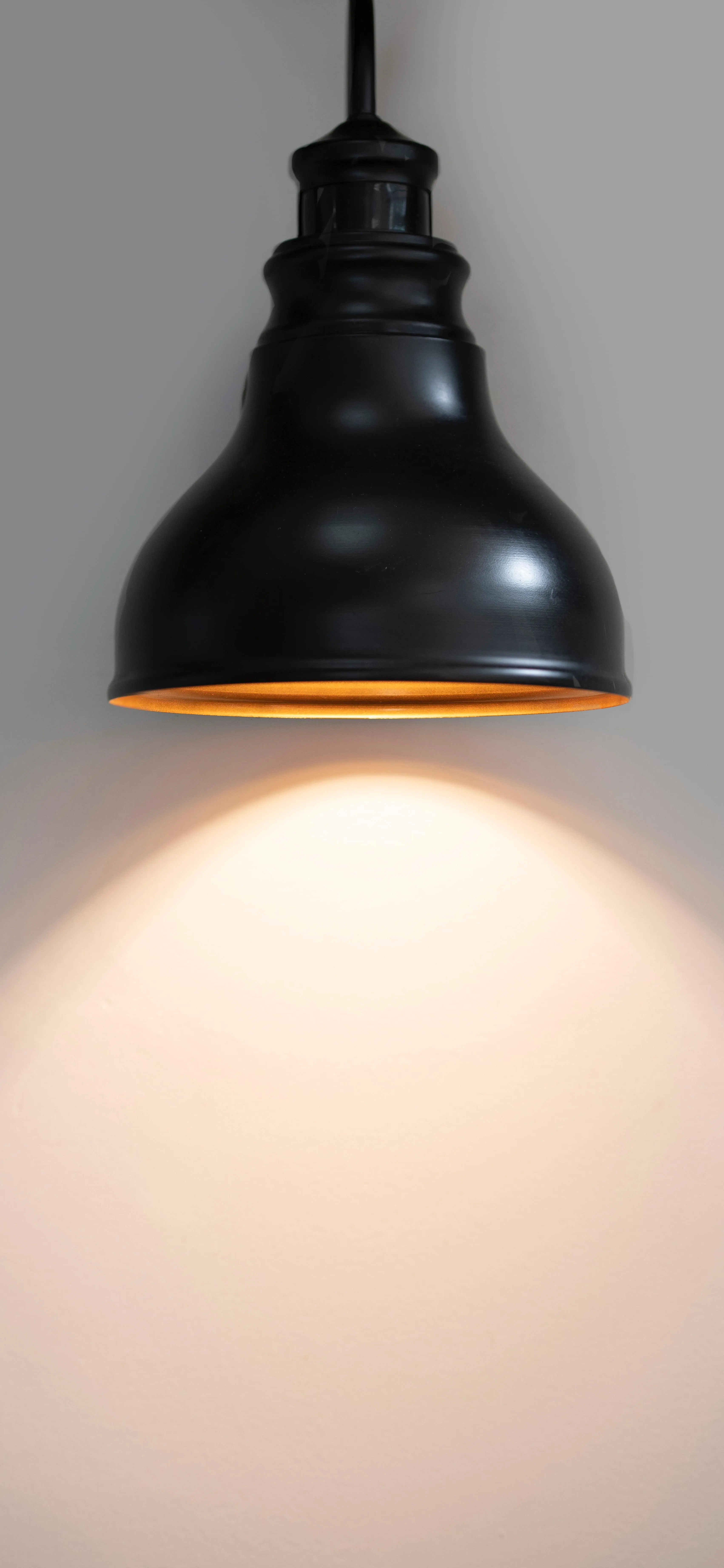 Minimalist Wall Lamp Casting Warm Light Glow Wallpaper