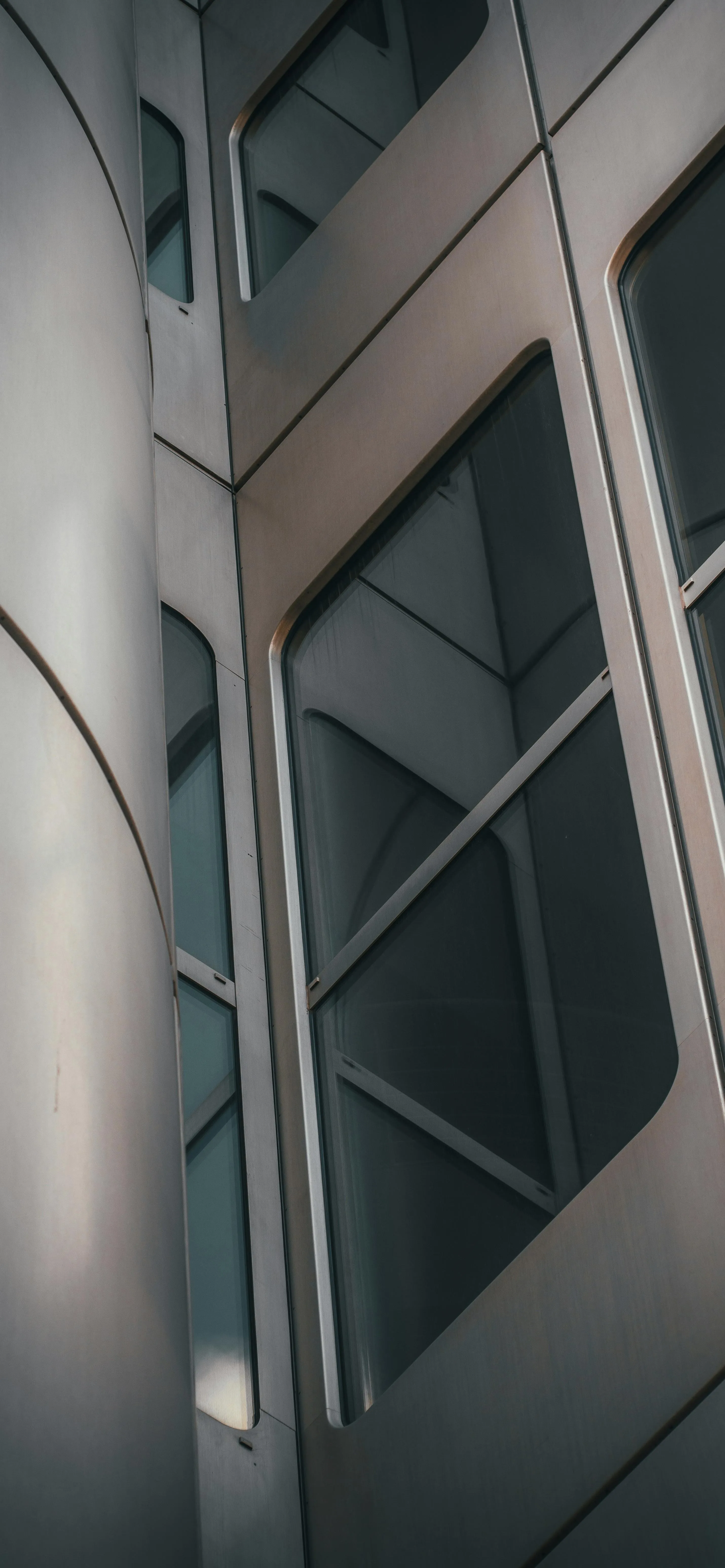 Modern Glass Building Windows Reflecting Sky and Architecture