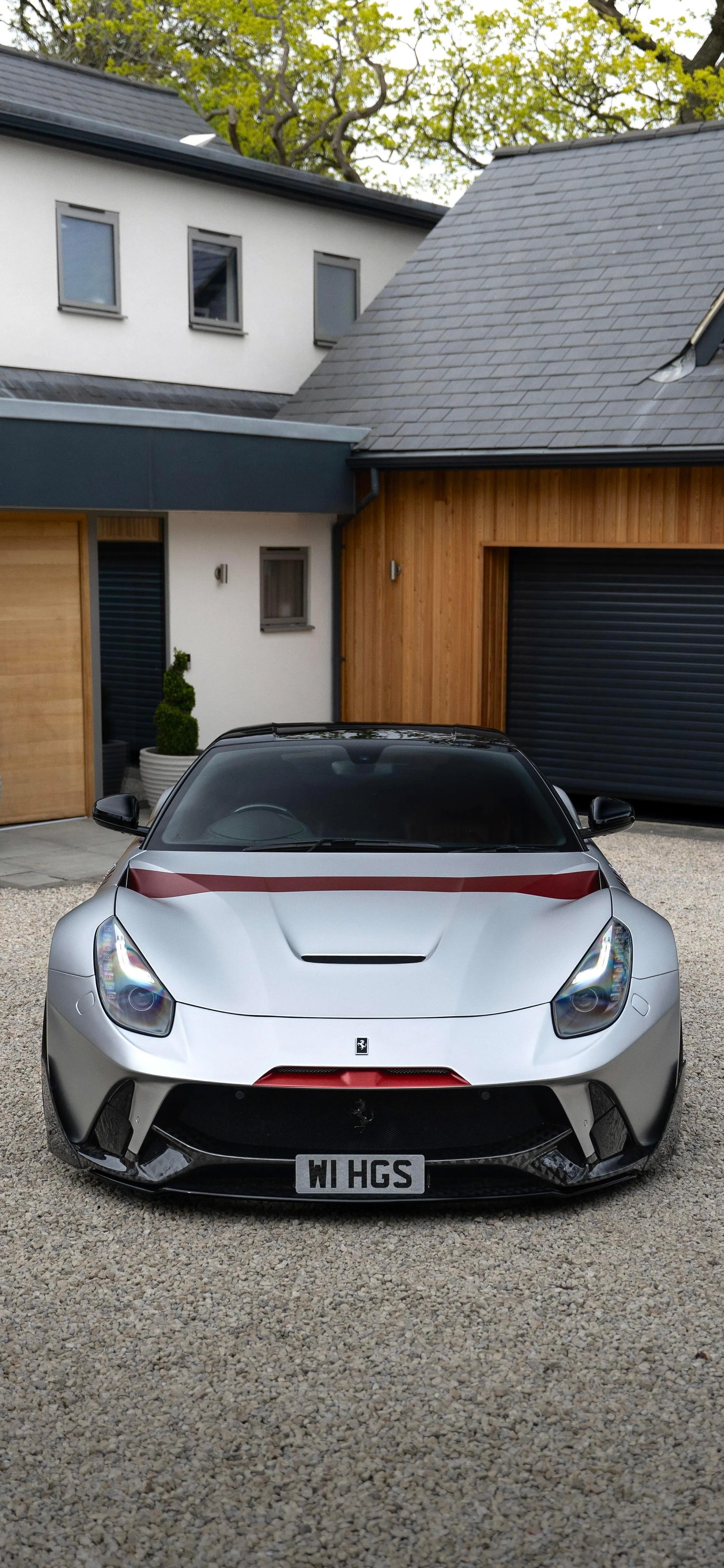 Modern Silver Sports Car Parked on Urban Residential Driveway