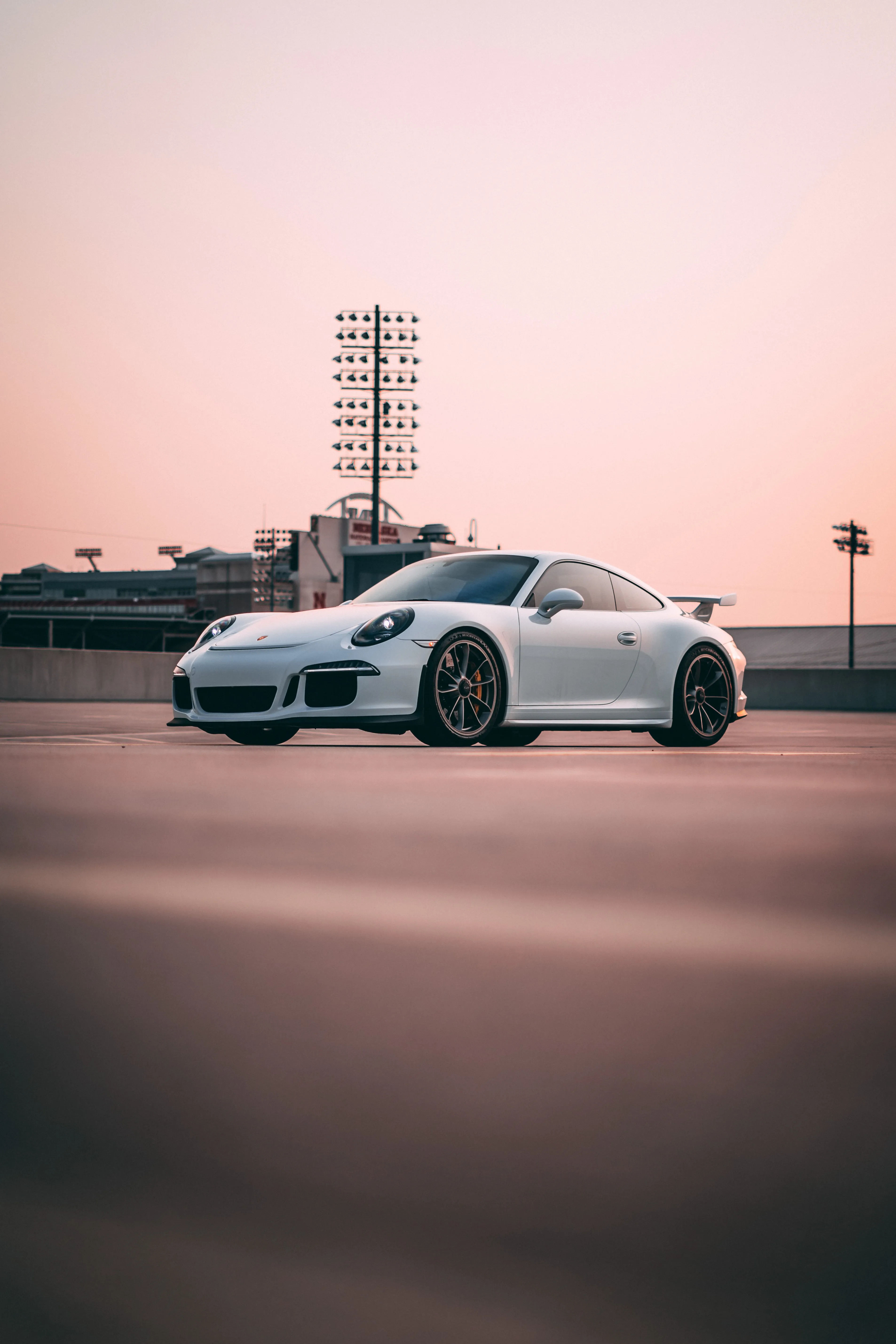 Modern White Sports Car at the Race Track Wallpaper