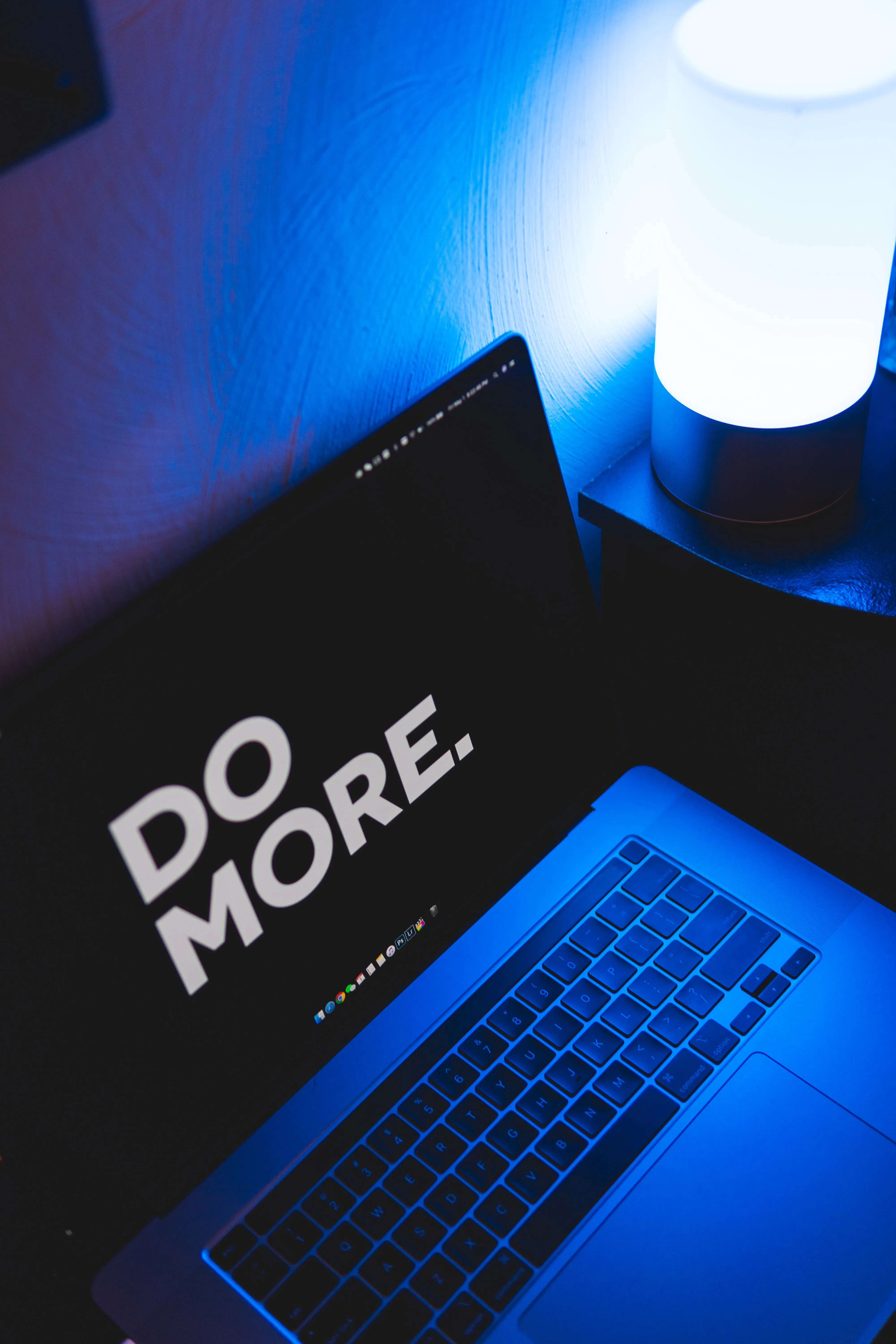 Motivational Laptop Workspace with Blue Light Wallpaper