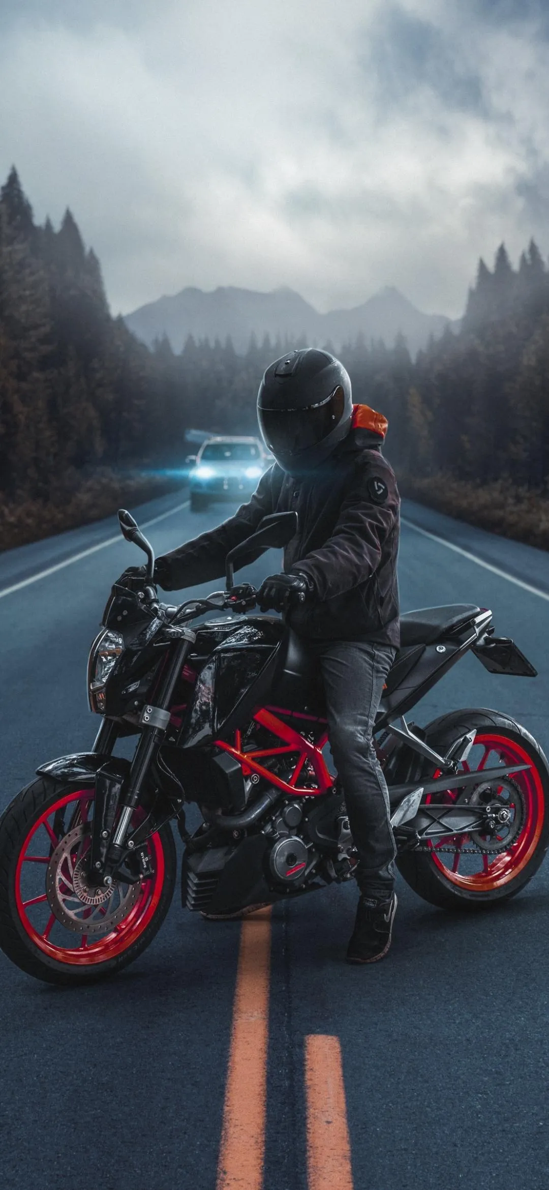 Motorcycle Rider Wearing Helmet On Road Surrounded By Fog