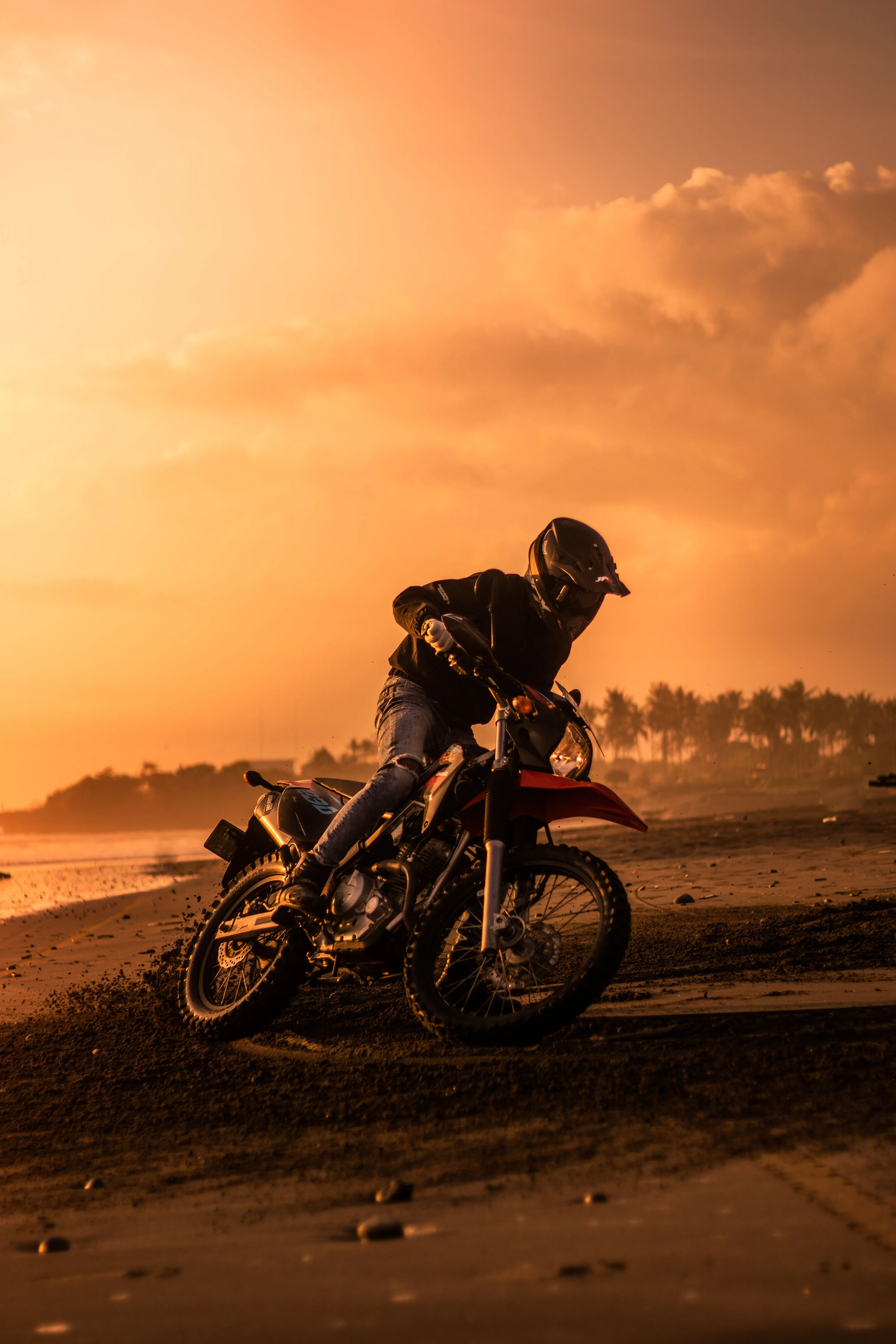 Motorcyclist Riding in Sunset Desert Light Wallpaper
