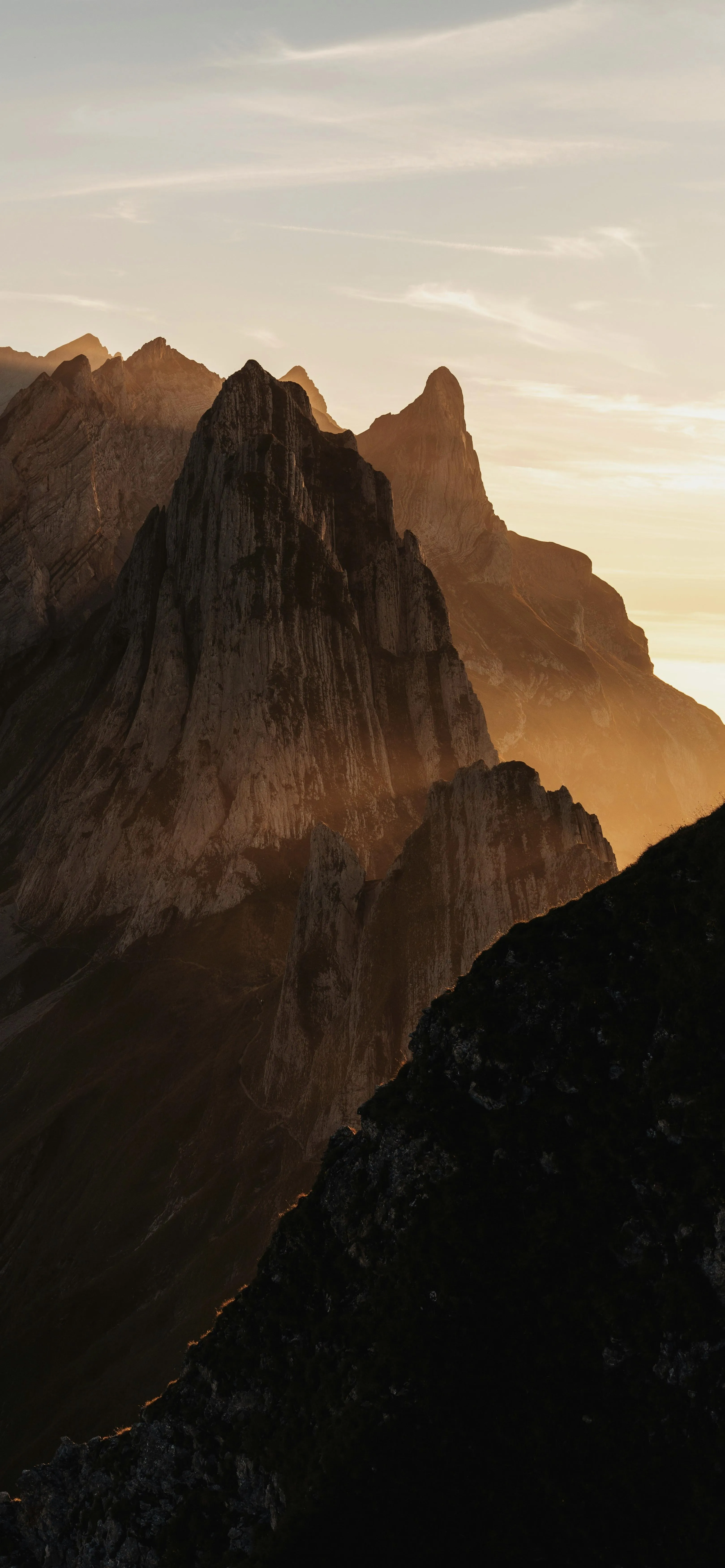 Mountain Peaks at Sunset with Dramatic Sky and Shadows