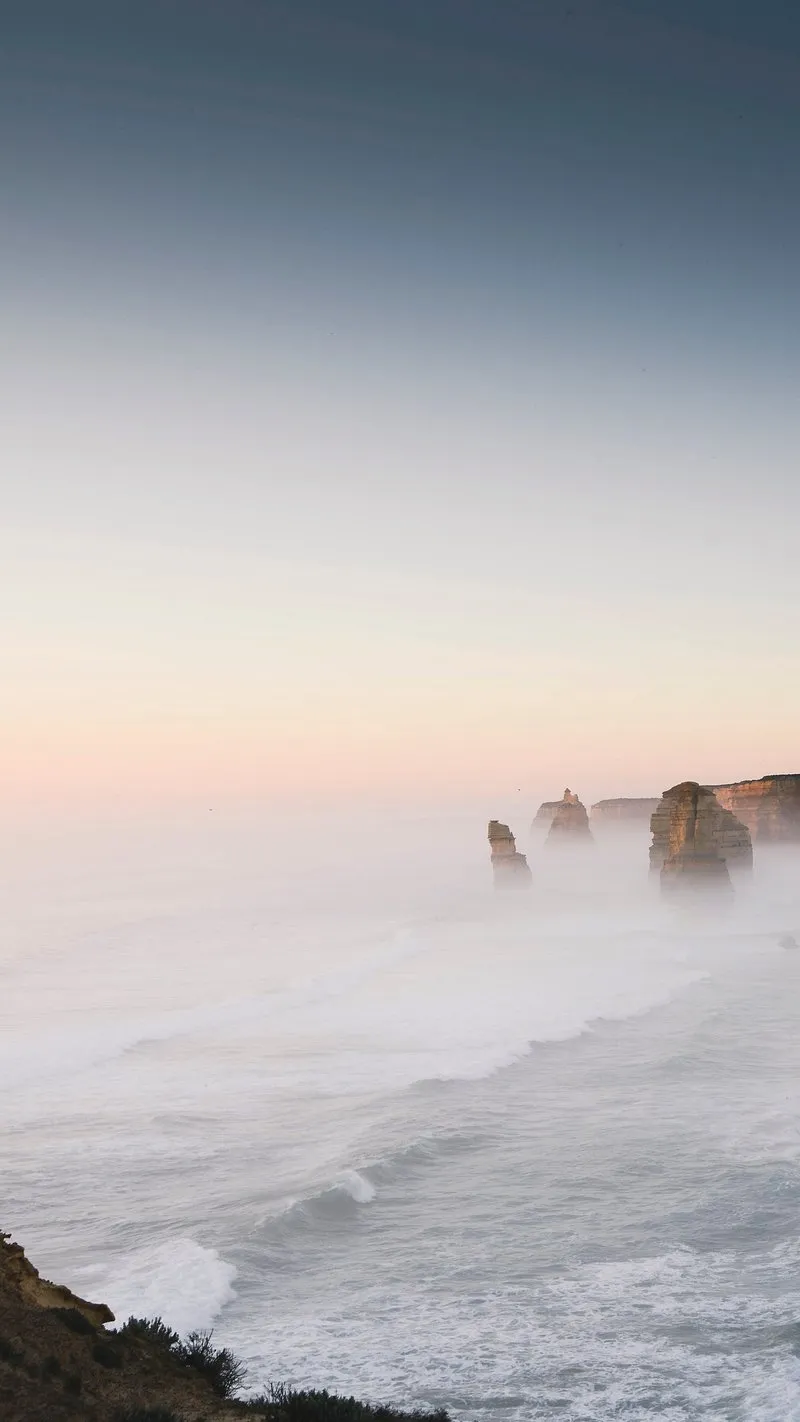 Mountain Peaks Emerging Above Clouds in Warm Golden Light