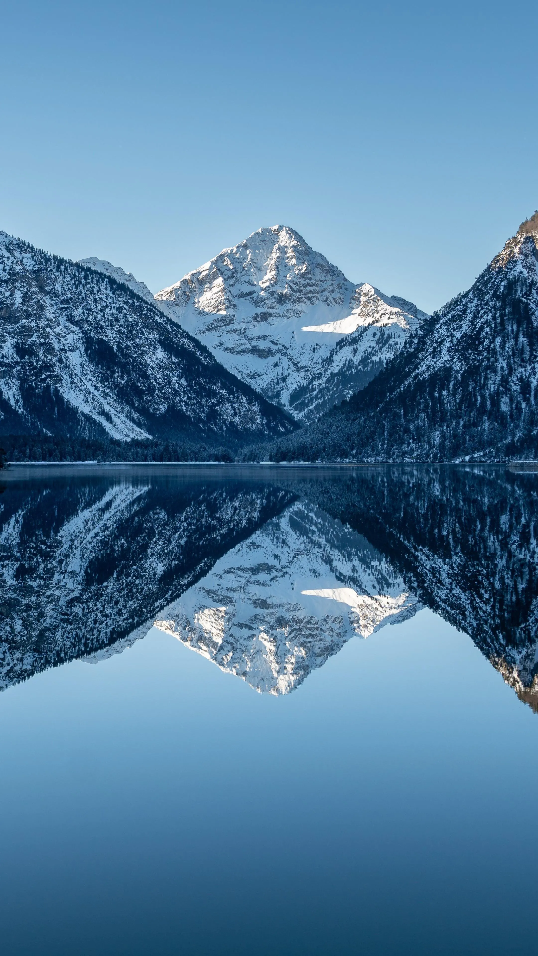 Mountain Peaks Reflecting in Still Lake Waterscape Image