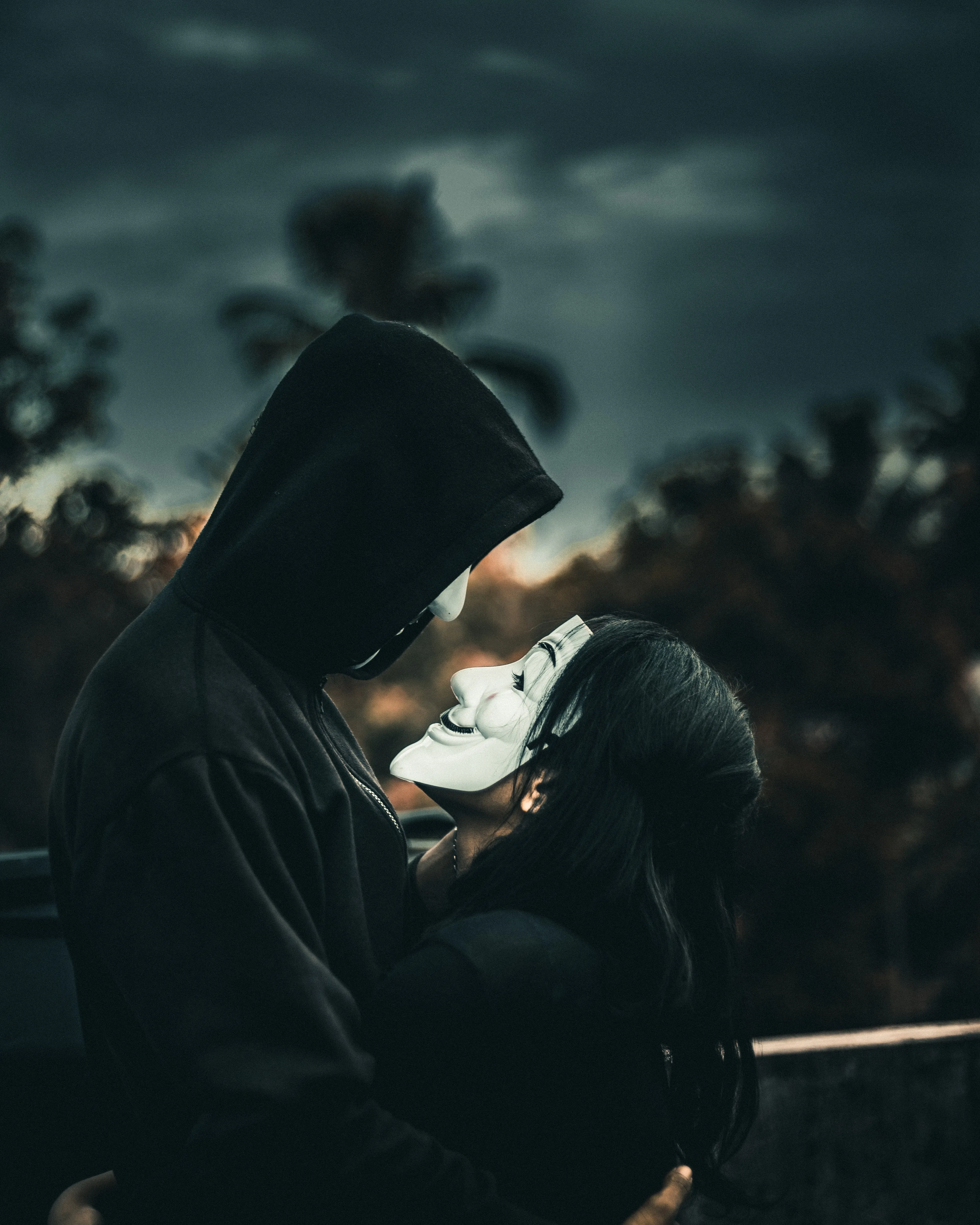 Mysterious Couple Sharing Love Behind White Masks Image