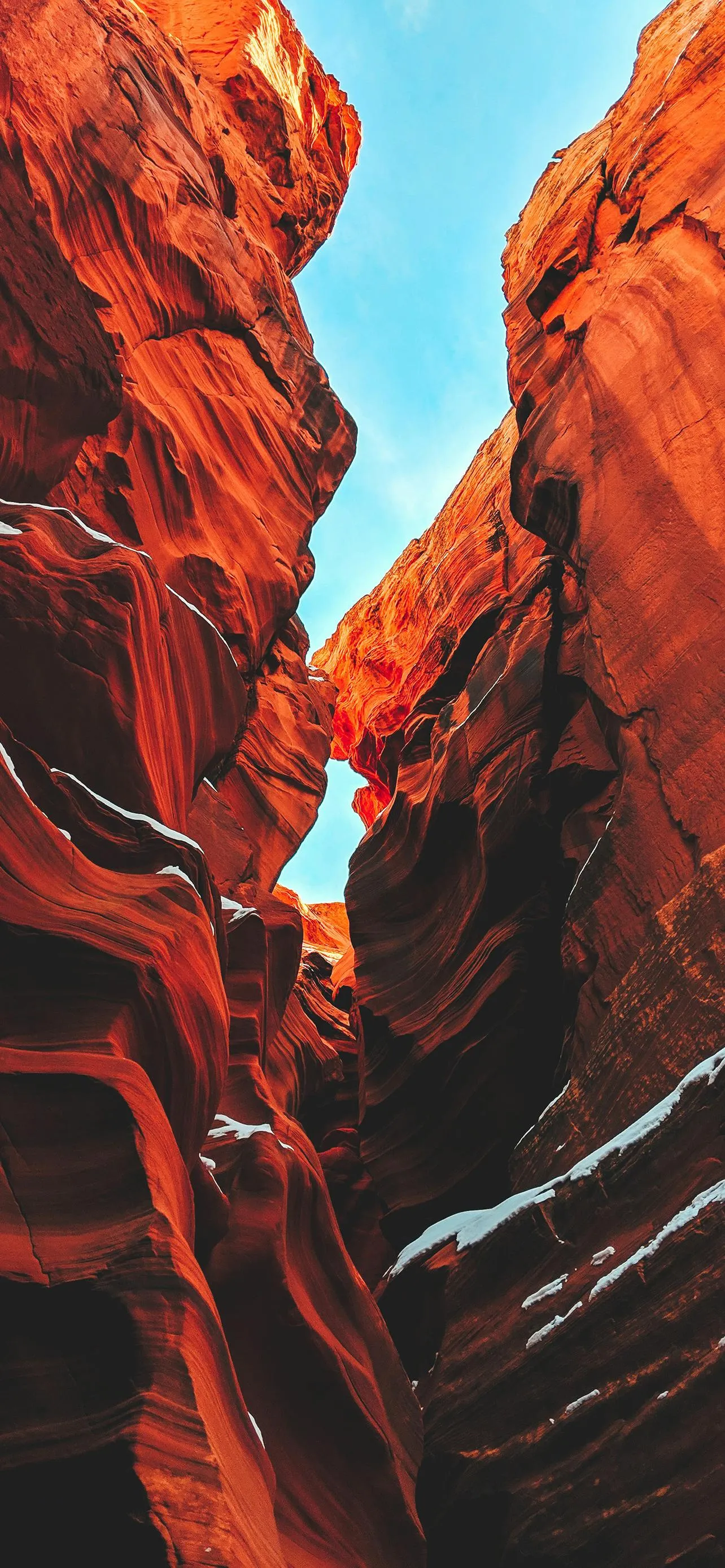 Narrow Canyon with Red Rock Walls and Bright Sunlight