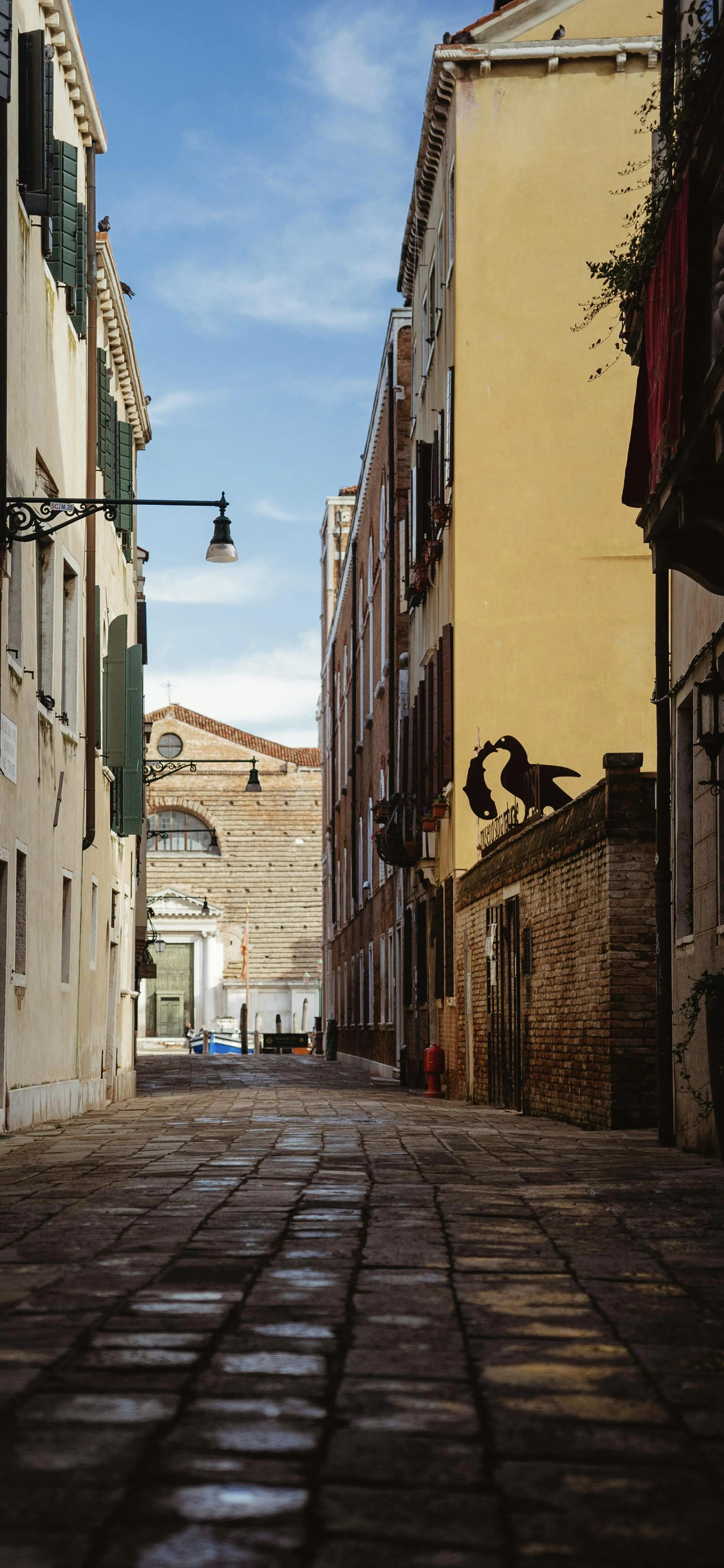 Narrow European Alleyway with Old Buildings and Cobblestone